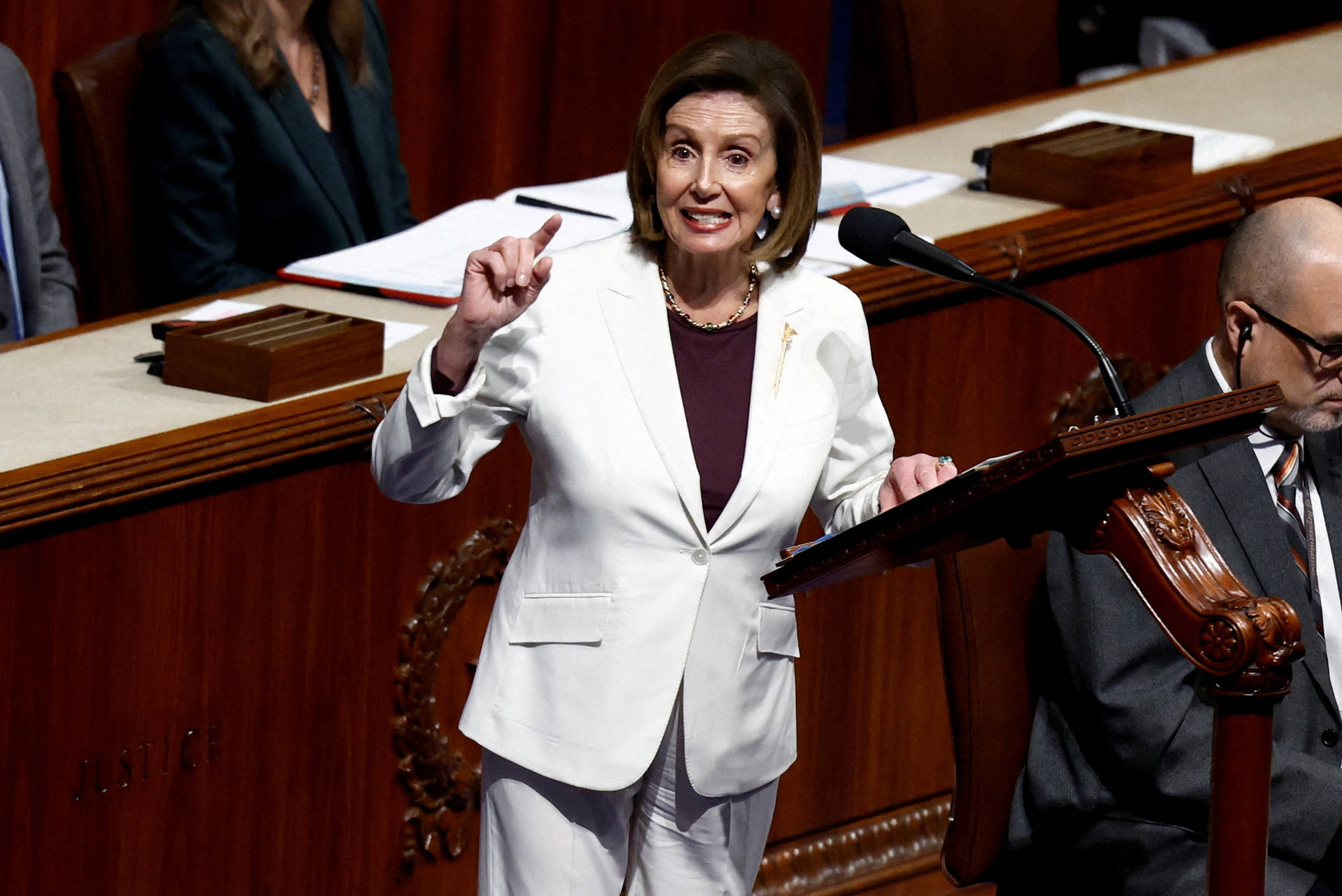 U.s. Speaker Of The House Nancy Pelosi In A Chic White Pantsuit Background