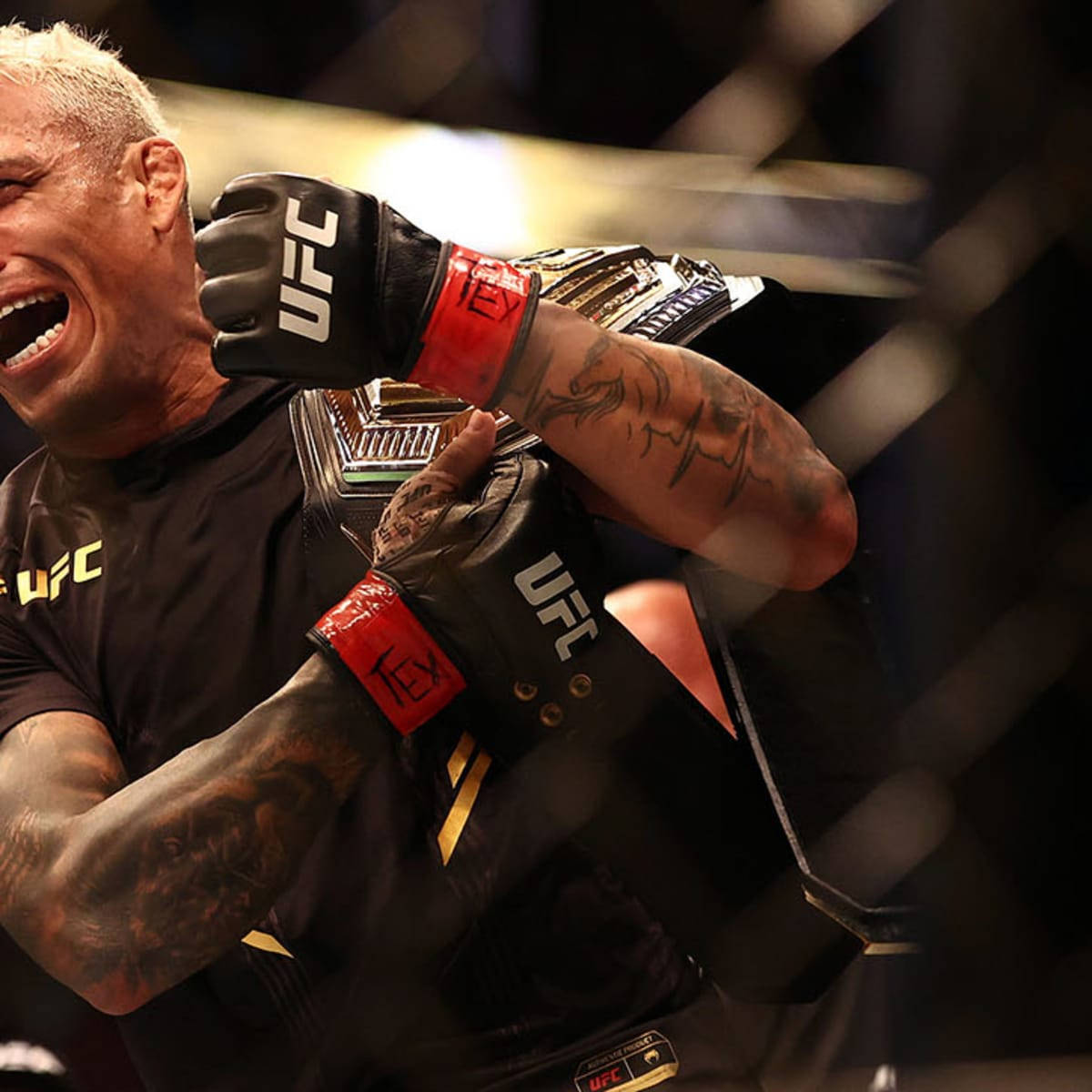 Ufc Champion, Charles Oliveira Showcasing His Championship Belt. Background