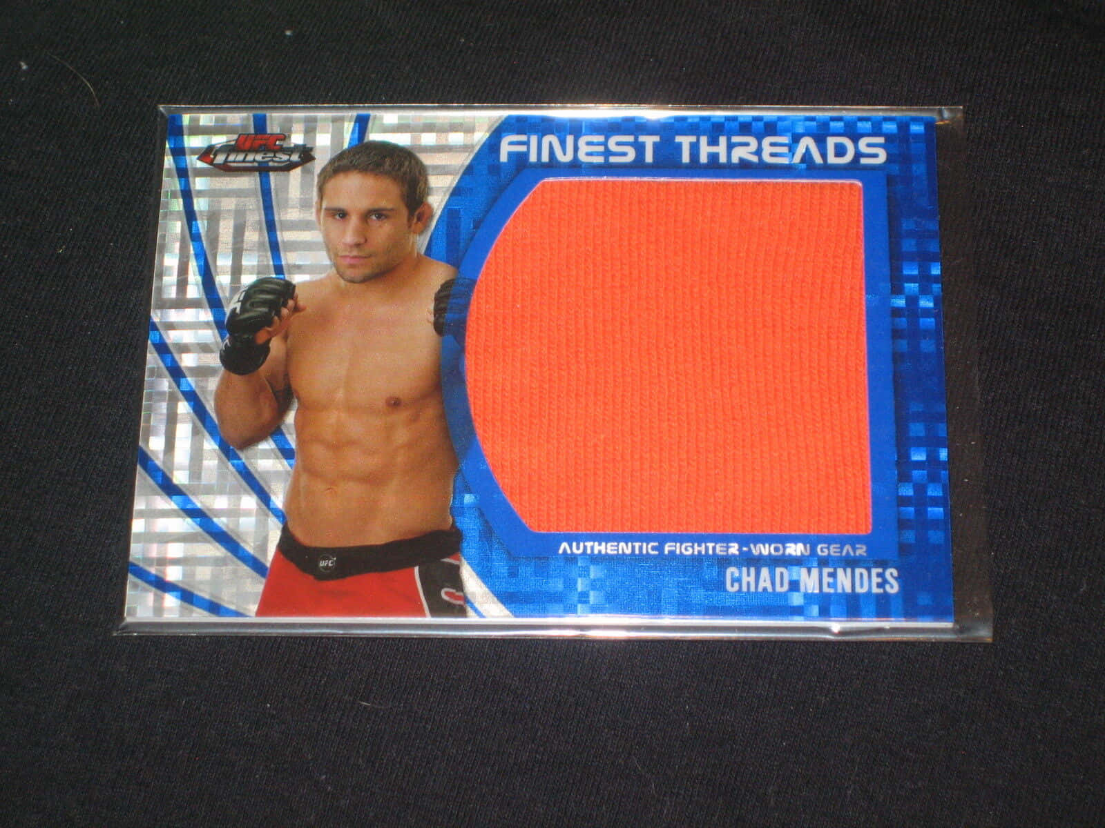 Ufc Star Chad Mendes Displaying His Memorabilia Card Background