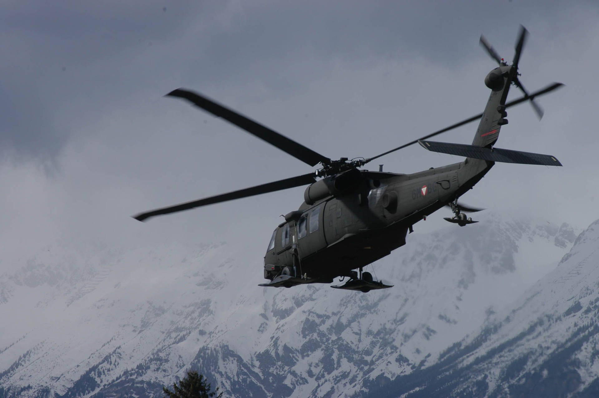 Uh 60 Black Hawk Helicopter Against Icy Mountain Background