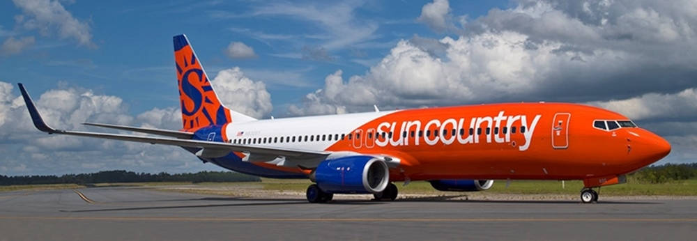 Ultrawide Shot Of Sun Country Boeing 737 Background