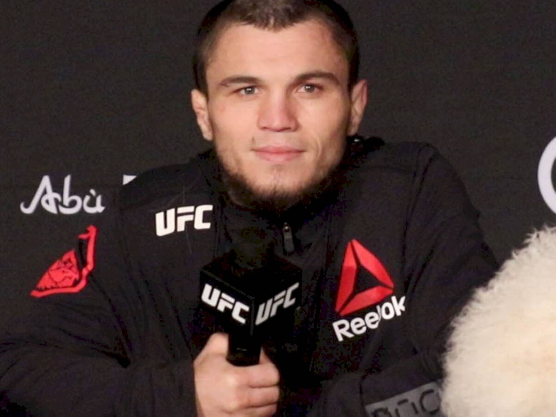 Umar Nurmagomedov Smiling At The Camera Background