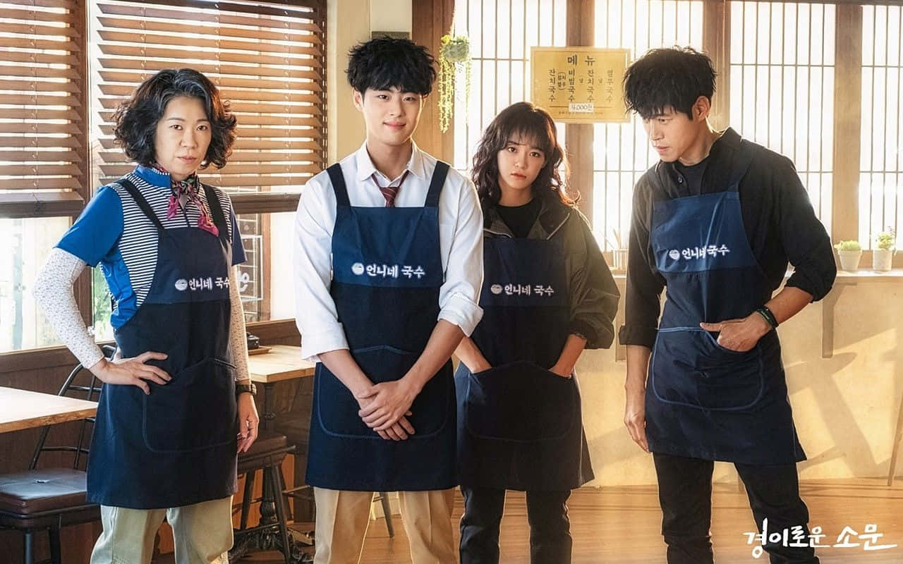 Uncanny Counter Cast Wearing Apron Background