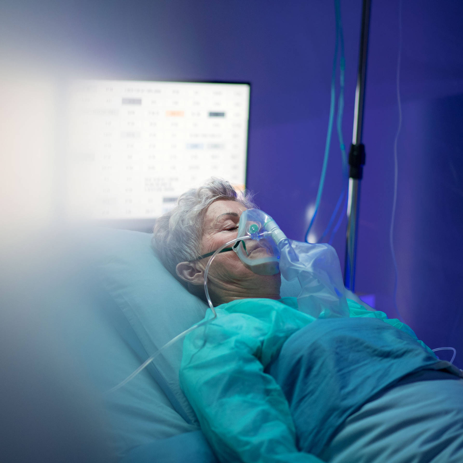 Unconscious Woman Receiving Medical Treatment In The Hospital Background