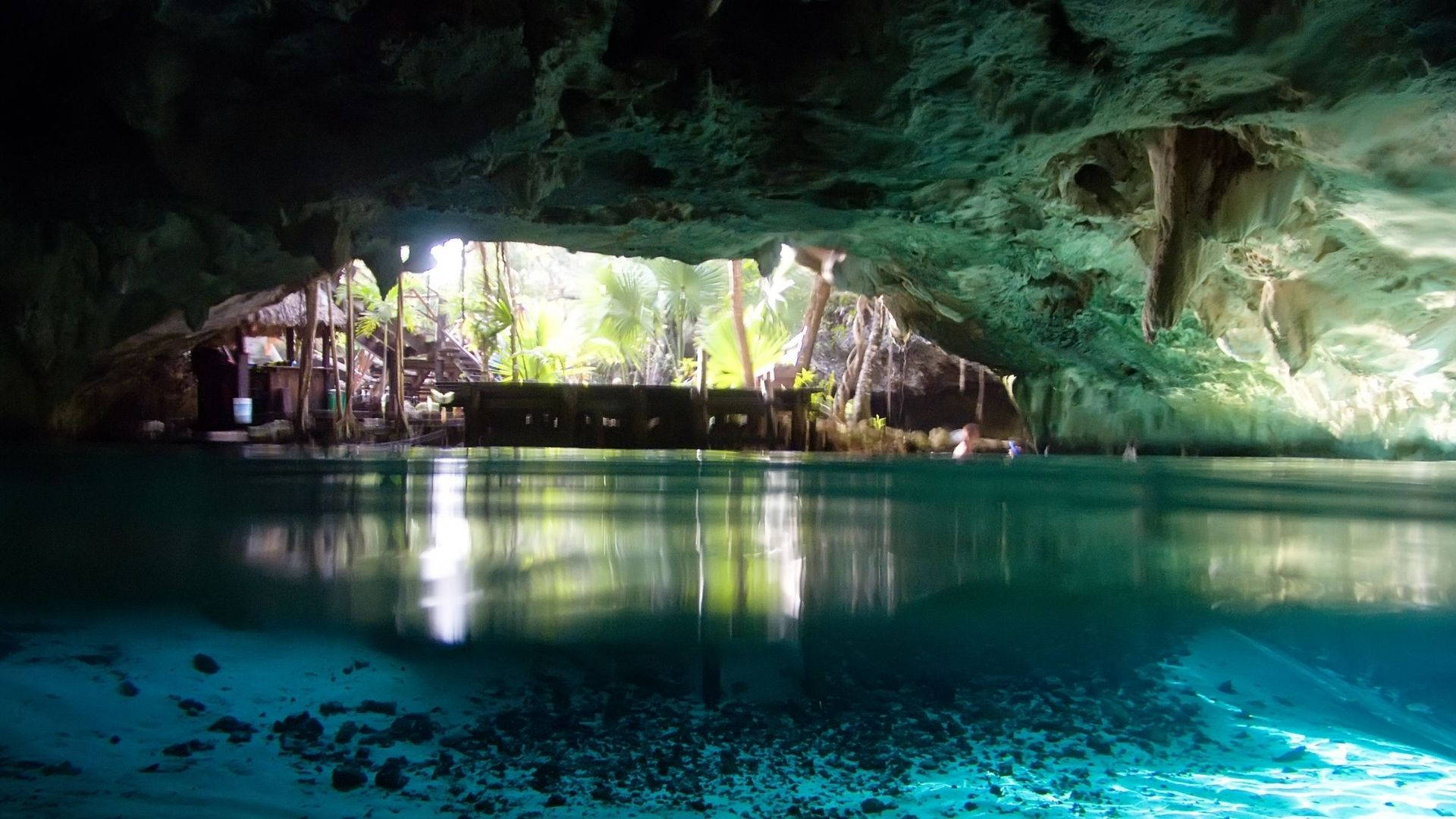 Underwater Cave Beside Nipa Hut Background