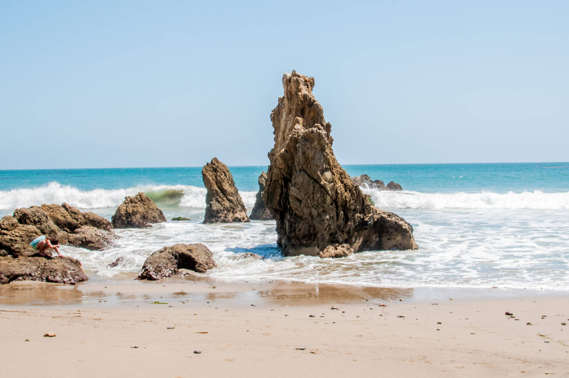 Unique Rock Formations On Malibu Beach Background