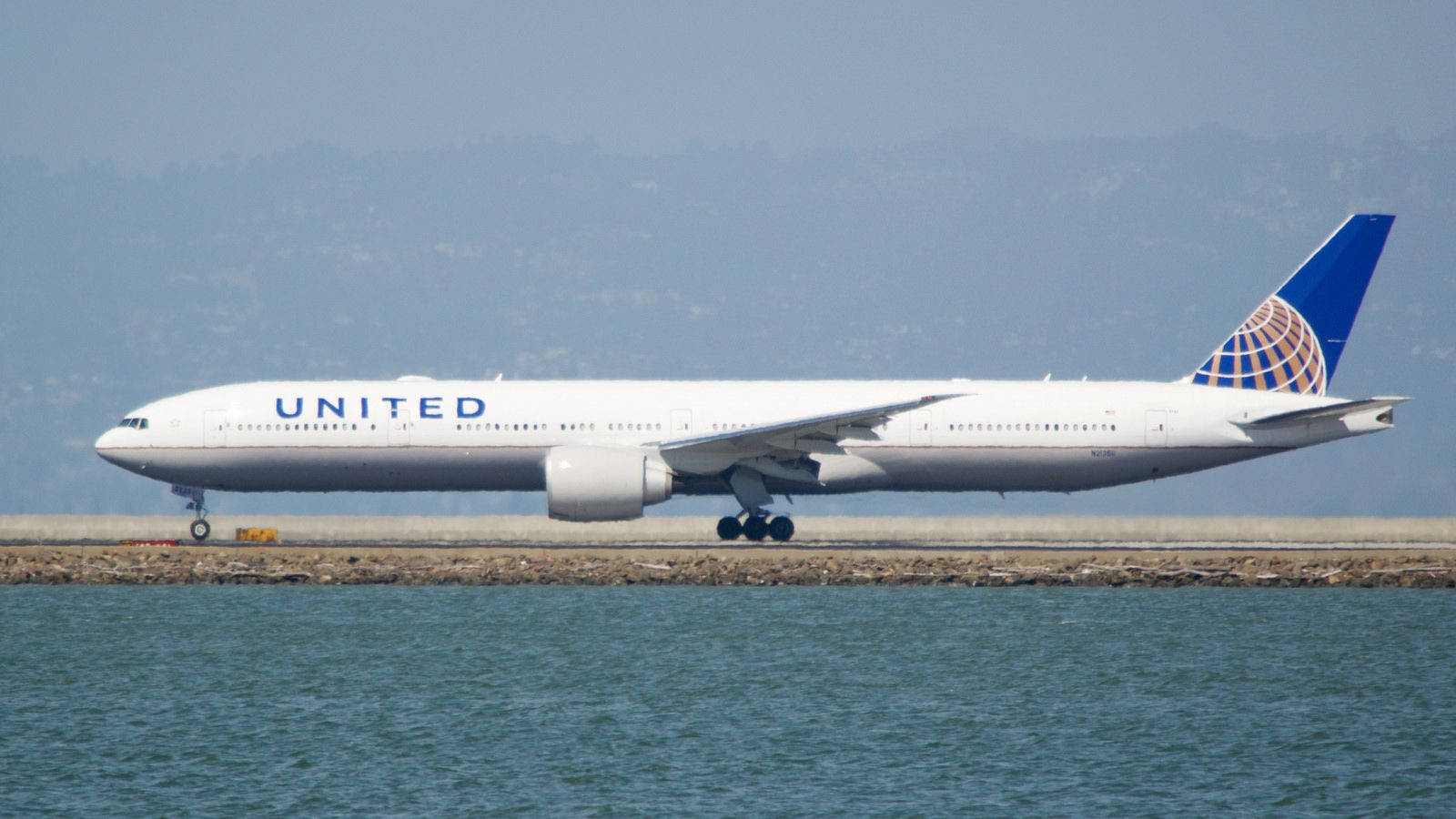 United Airlines Plane On Ocean Runway