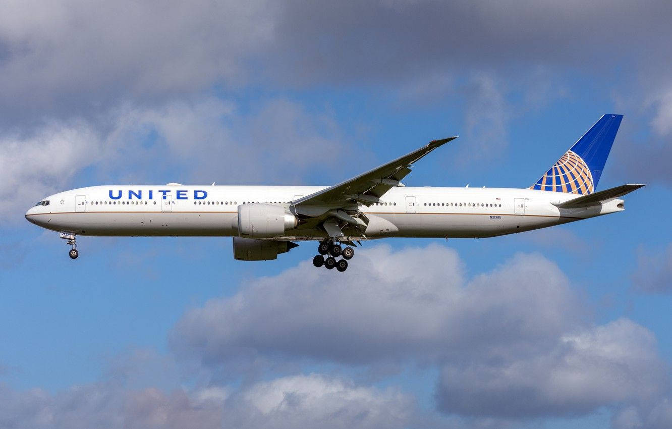 United Airplane Soaring Against Cloudy Sky