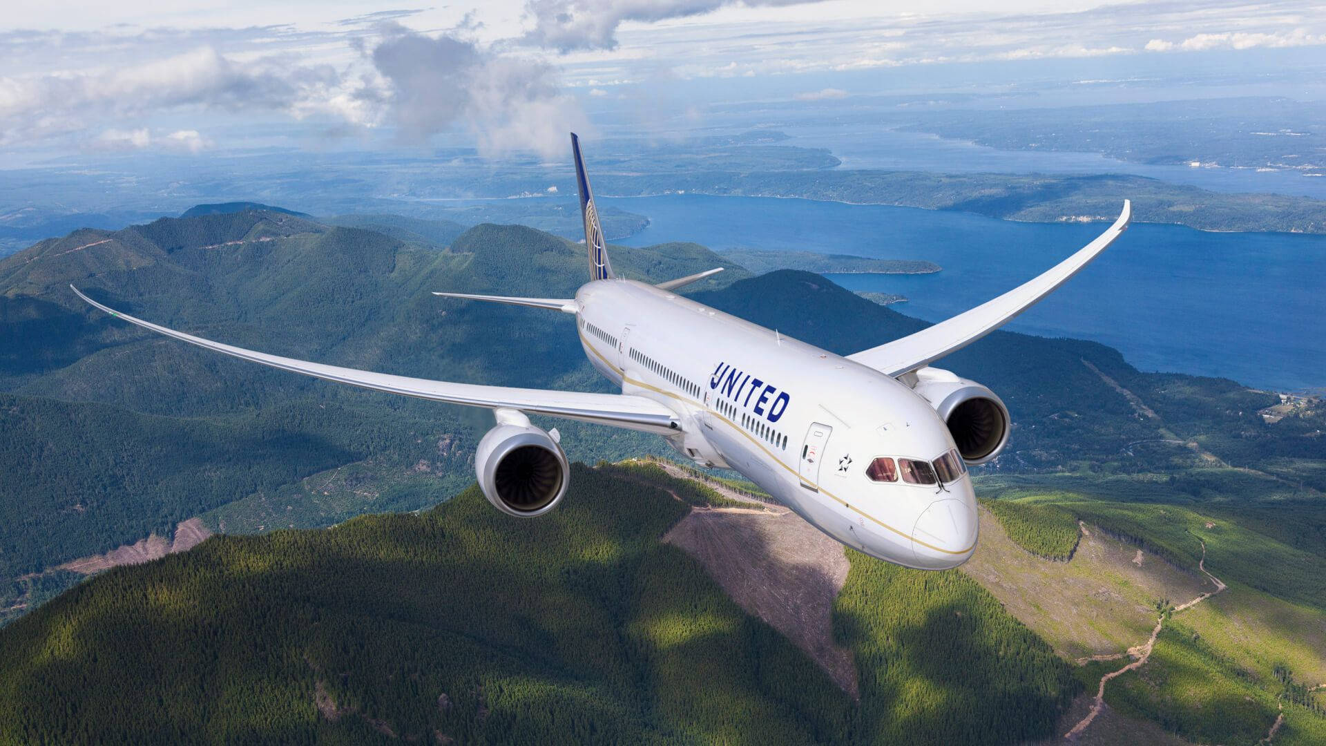 United Airplane Soaring Over High Mountains