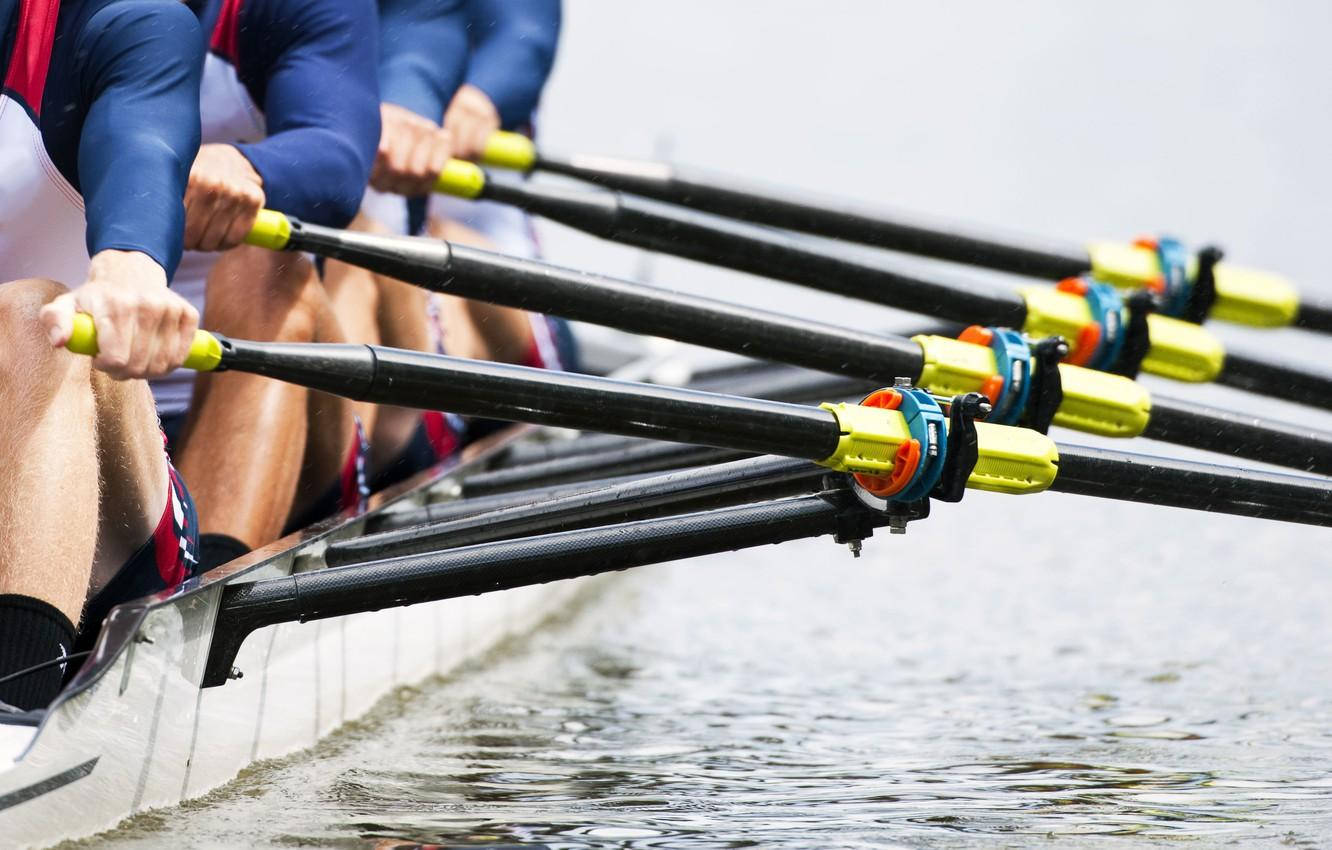 Unleashing Power And Grace On Water - A Close Up Of Rowing Oars Background