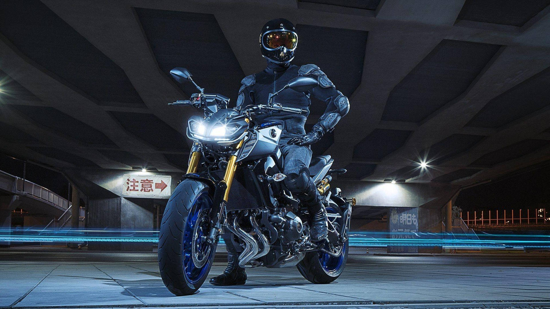 Unleashing Power - Rider With Black Yamaha Mt 15 Background
