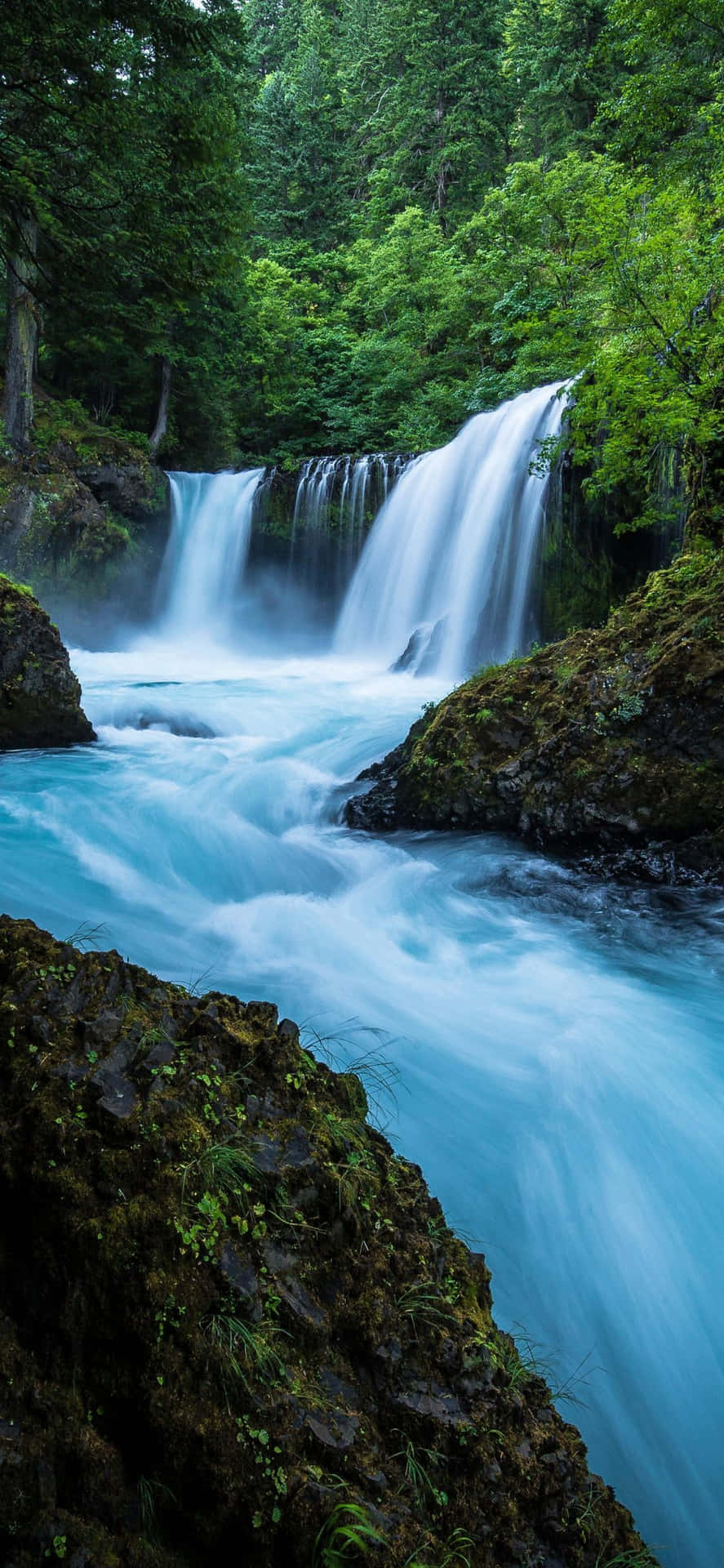 Unlock The Beauty Of A Flowing Waterfall Background