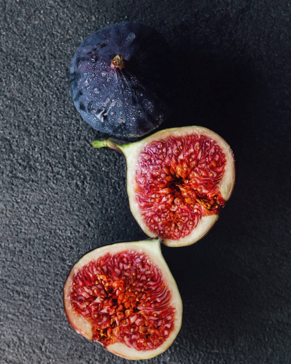 Unopened And Sliced Ripe Fig Fruits Background