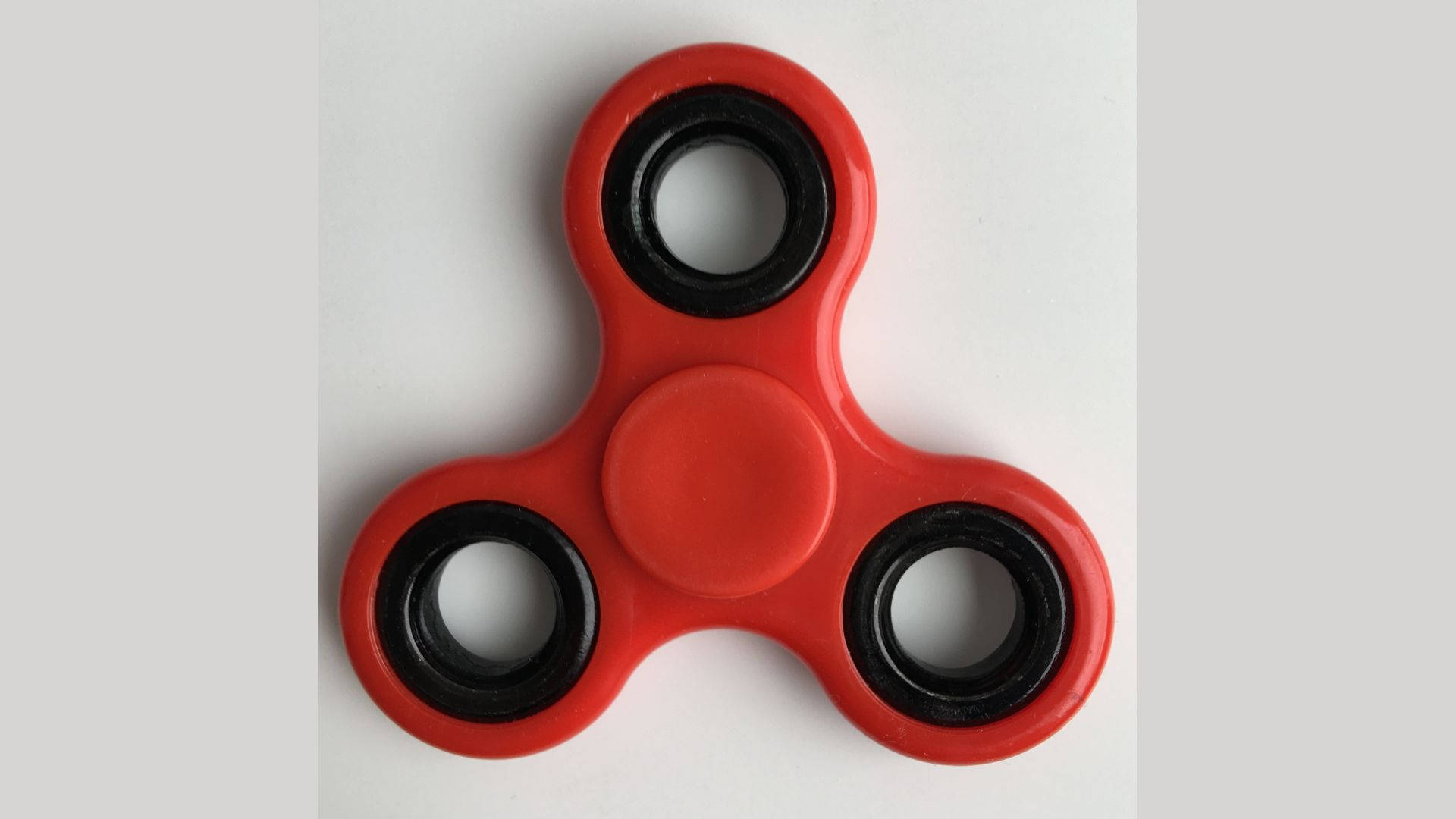 Unwind Your Thoughts With Red Fidget Toy Background