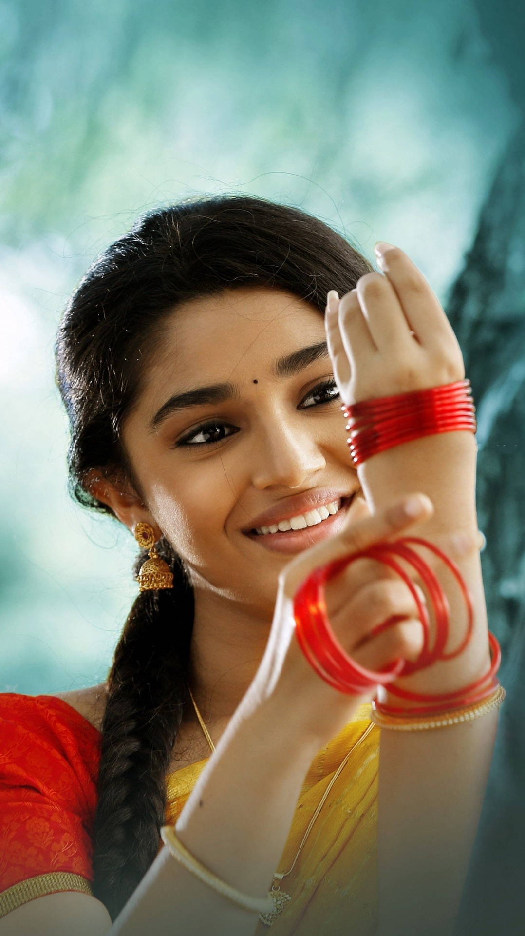 Uppena Sangeetha Adorned In Traditional Red Bangles Background