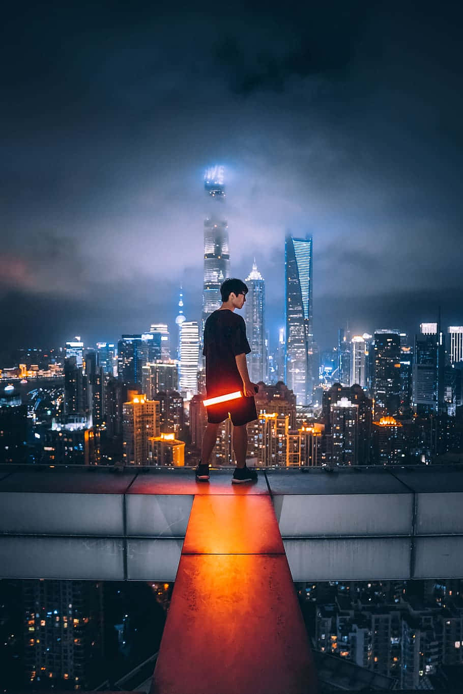 Urban Explorer Overlooking City Night Skyline
