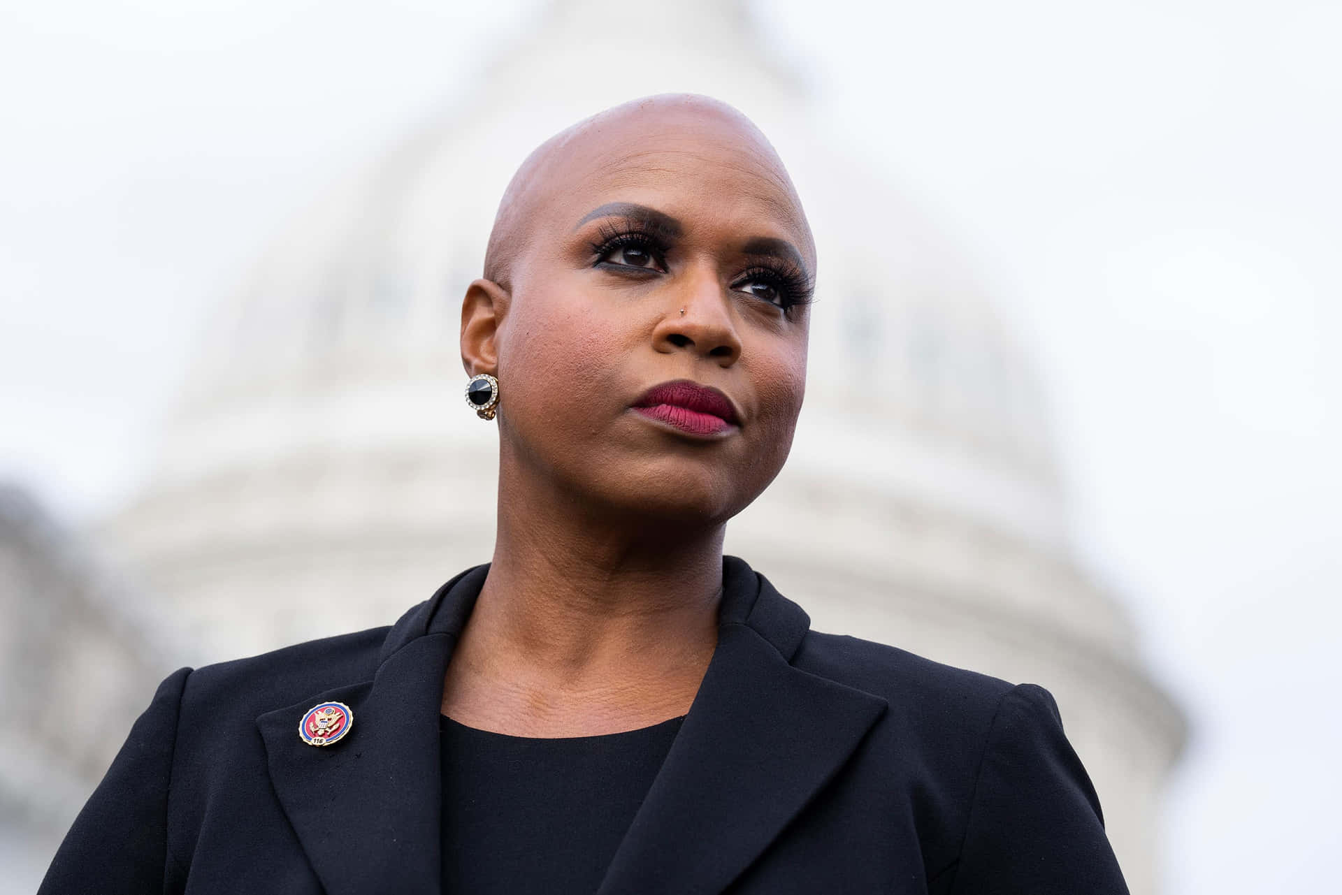 Us Representative Ayanna Pressley Posing With Serious Face In Front Of The Capitol Dome Background