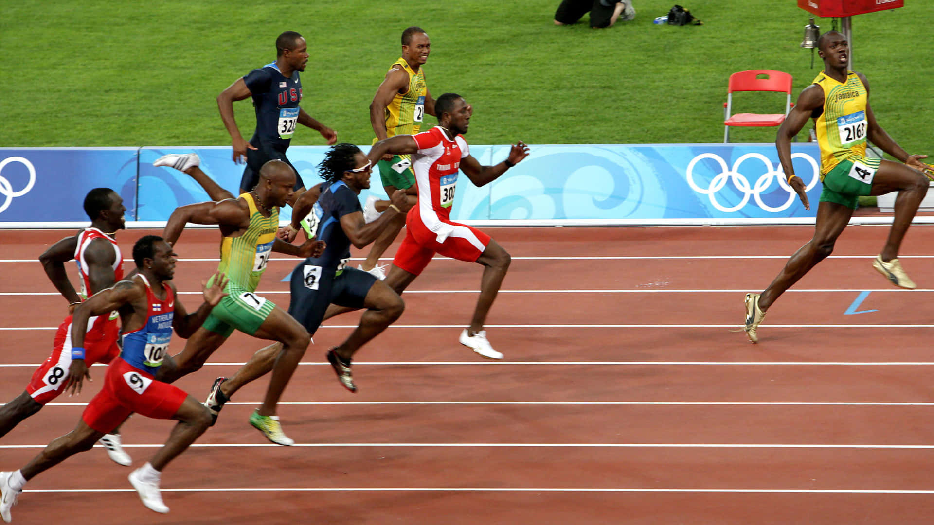 Usain Bolt Dashing Ahead Of Competition Background
