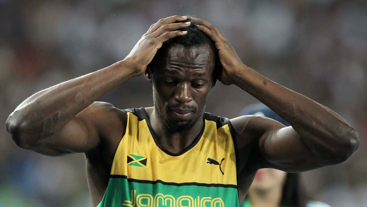 Usain Bolt Holding Head Both Hands Background