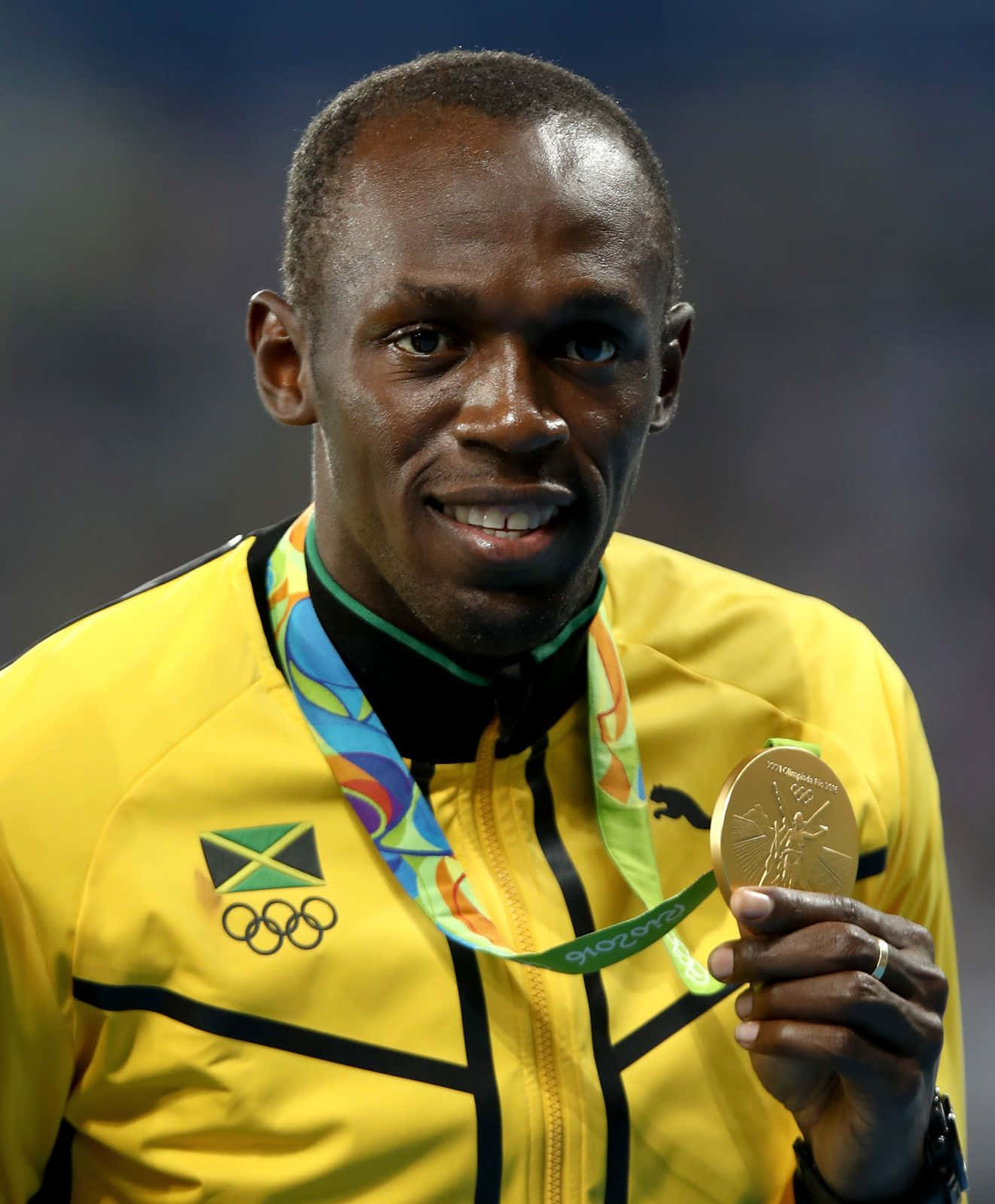 Usain Bolt Smiling With Medal Background