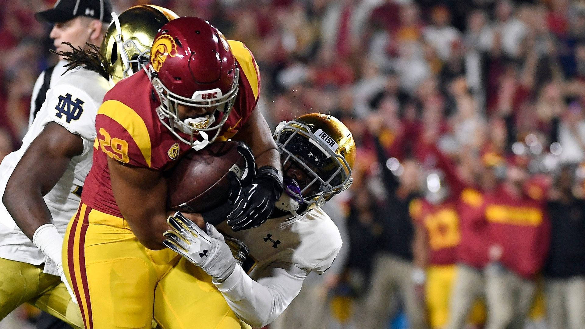 Usc Football Player Tackled Background