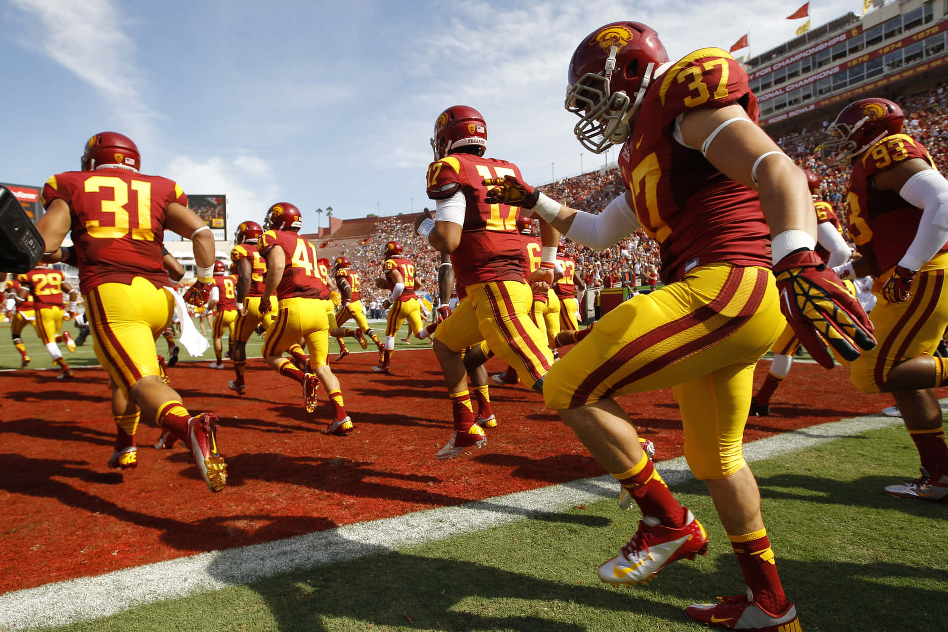 Usc Trojans Football Players In Action Background