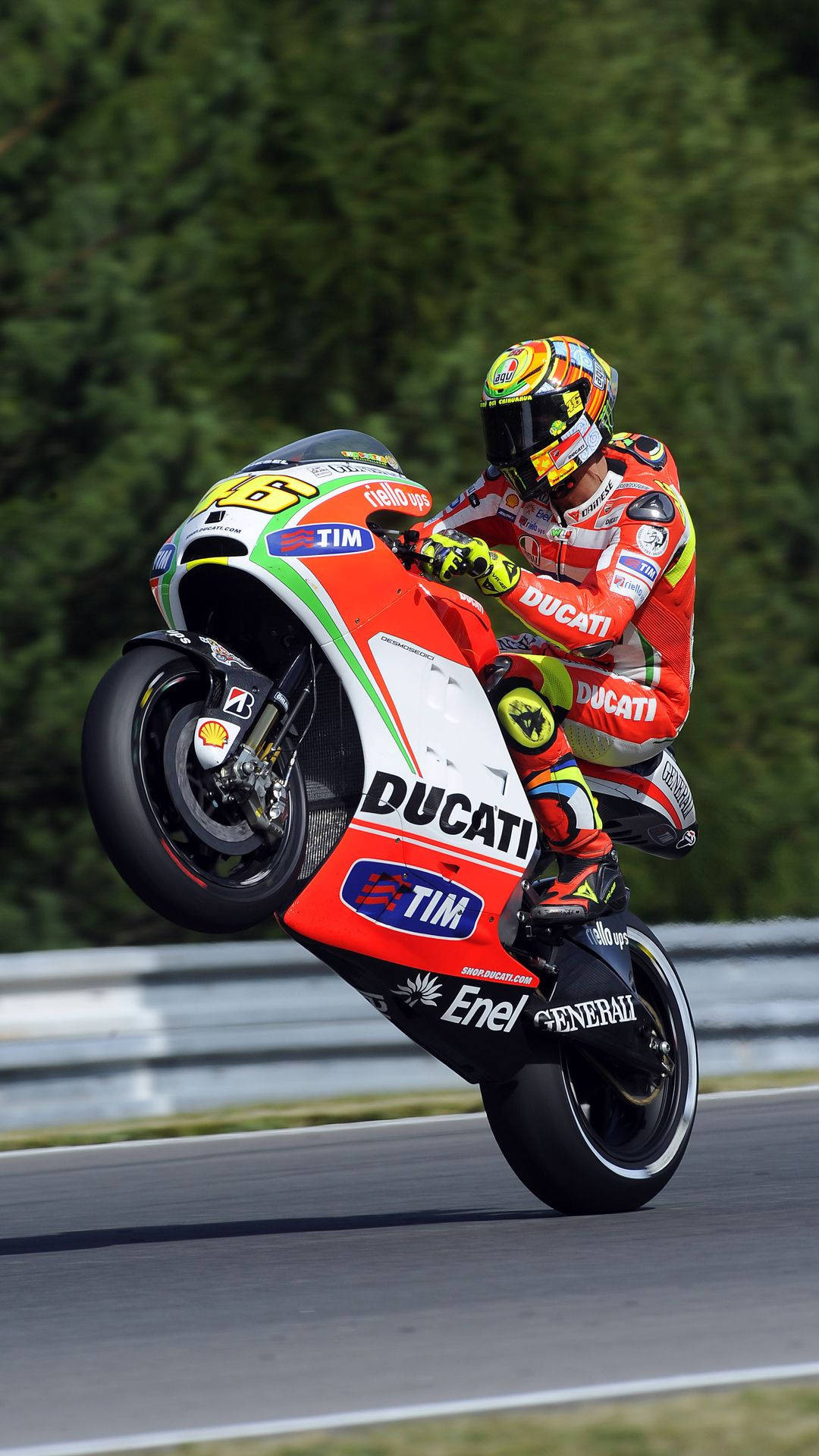 Valentino Rossi Racing On A Red Ducati Gp11 Background