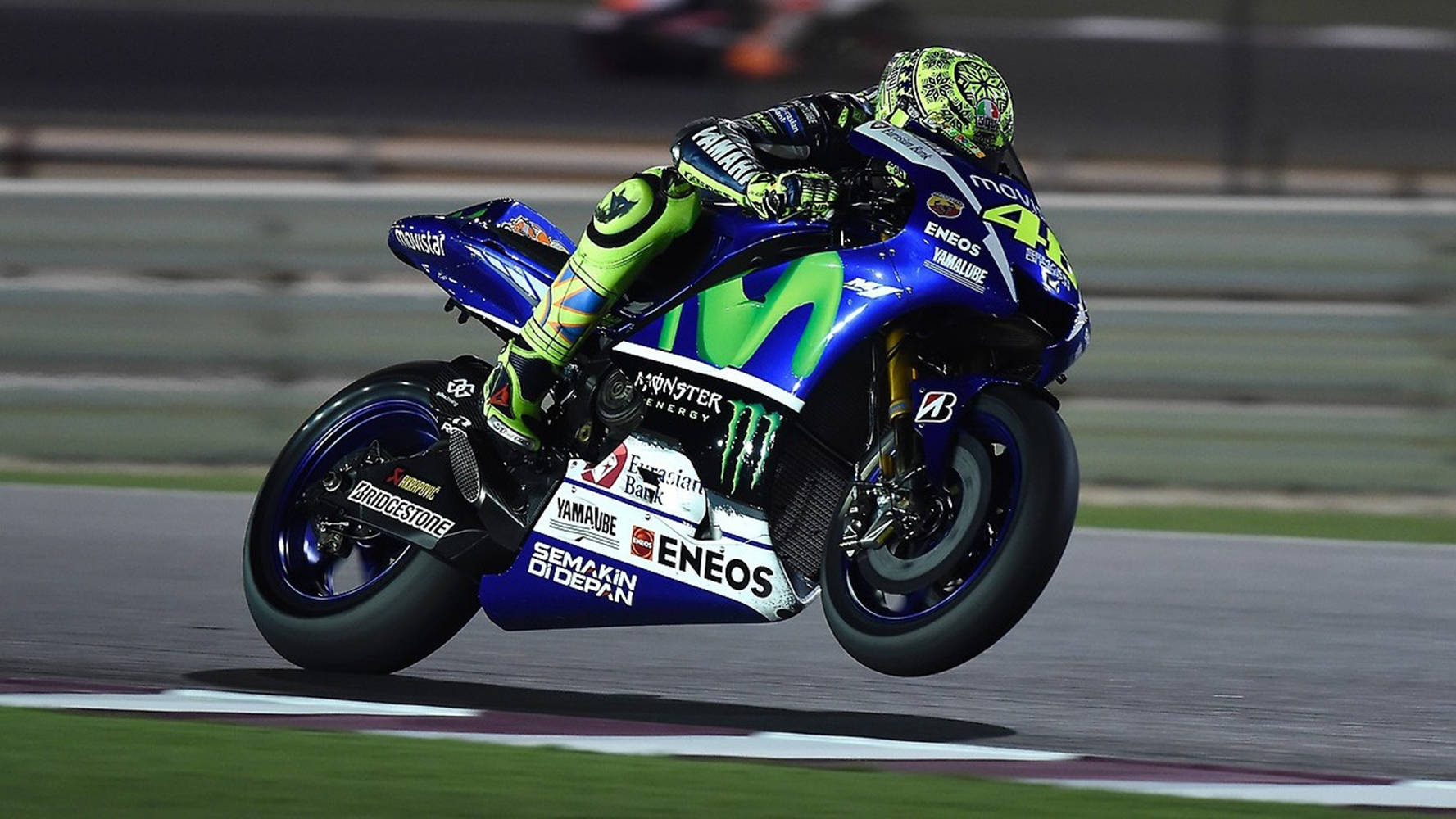 Valentino Rossi Racing On His 2018 Yamaha Prototype Bike Background