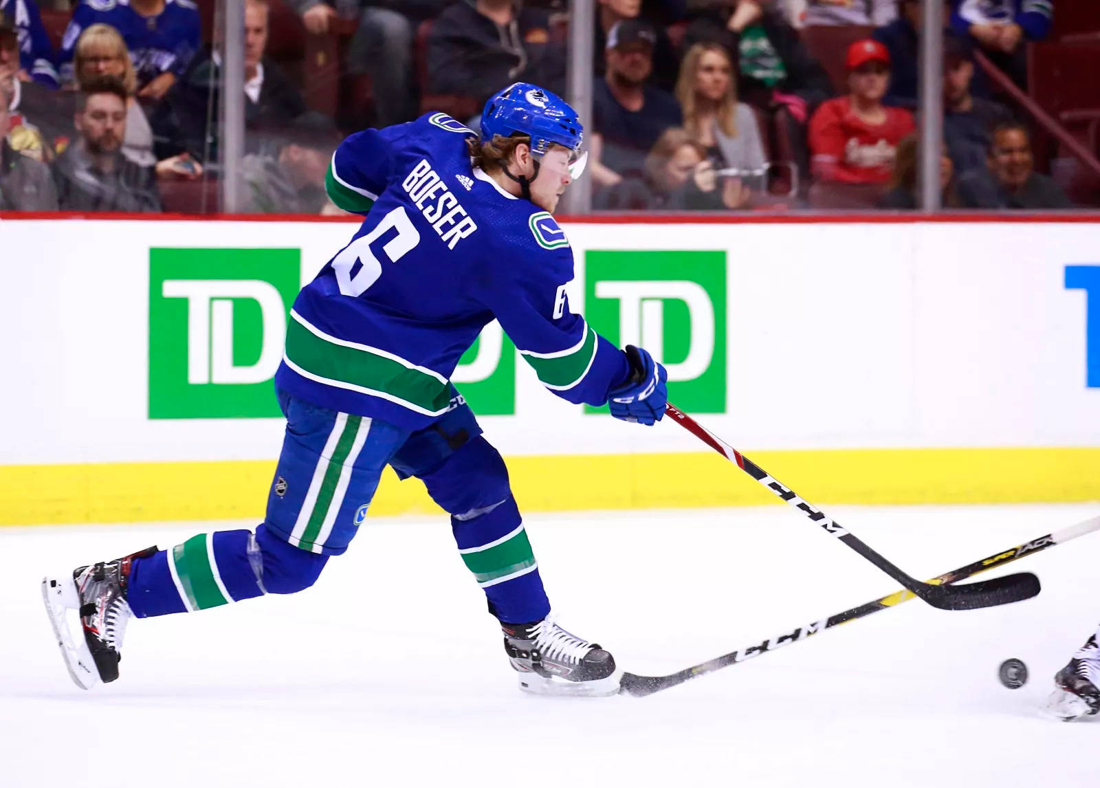 Vancouver Canucks’ Star Player, Brock Boeser, In Action Against Calgary Flames Background