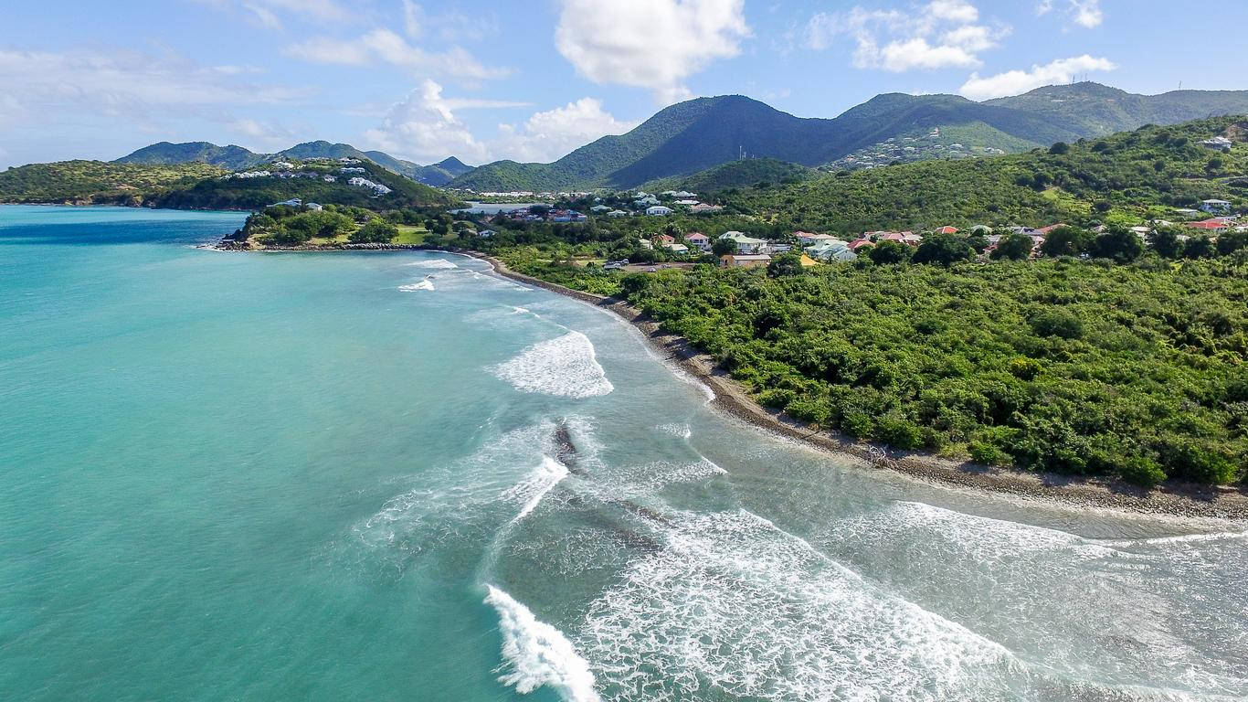 Vast Beach Waves At Sint Maarten's Shoreline Background