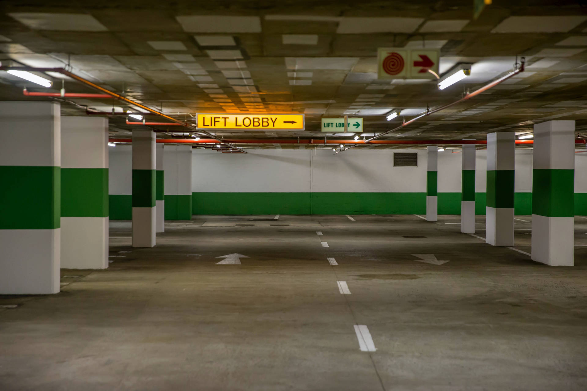 Vast Empty Underground Parking Area Background