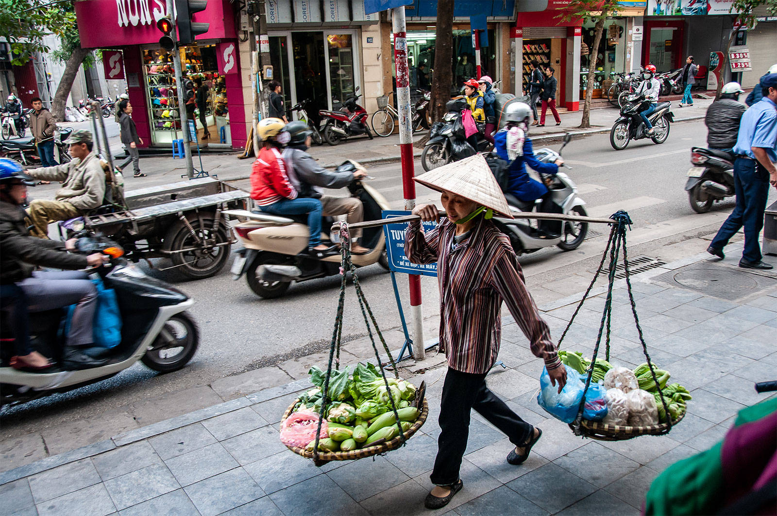 Vendor And Motorists In Hanoi Background
