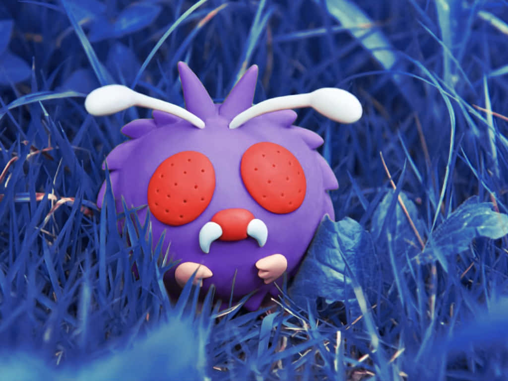 Venonat Toy On Blue Grass Background