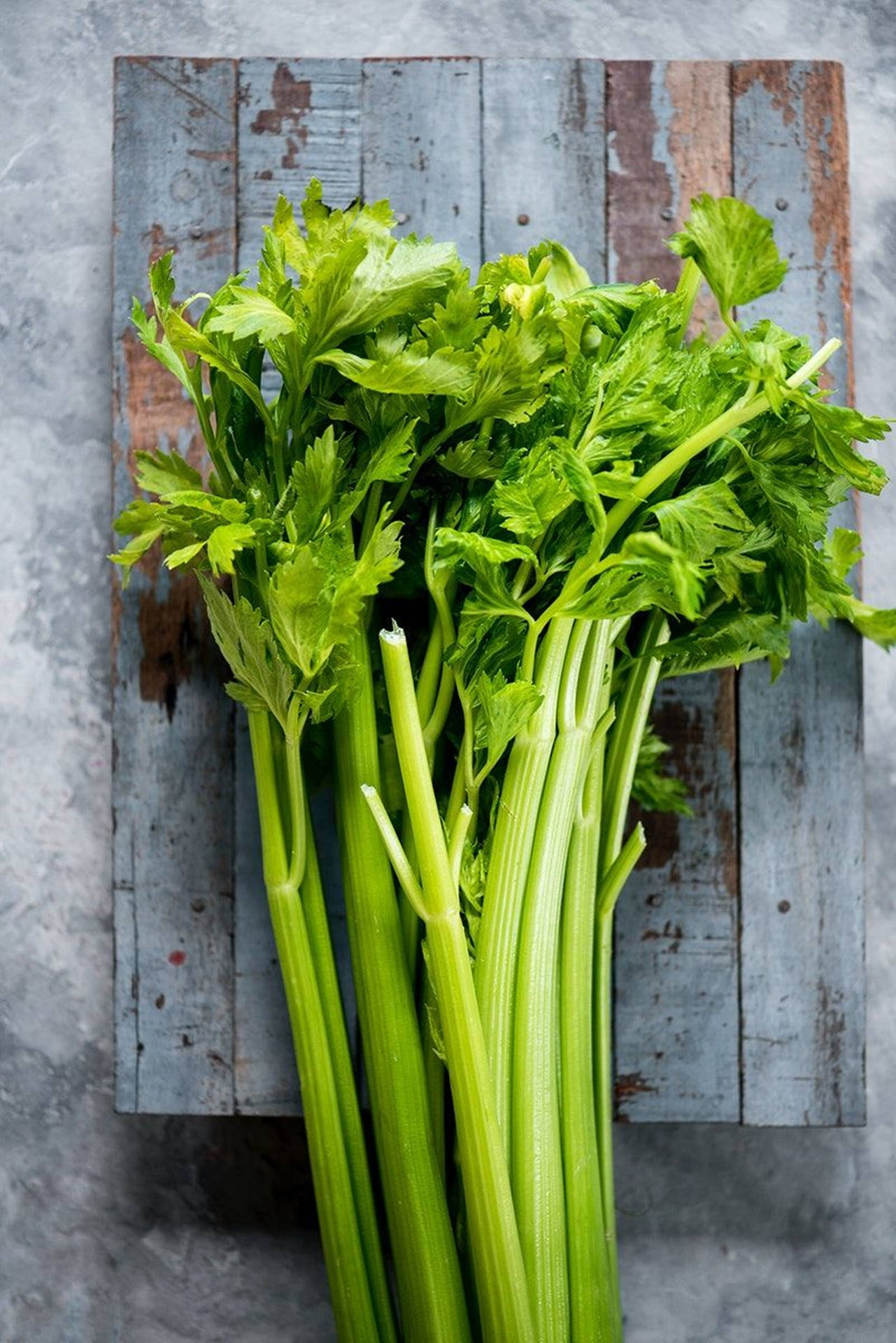 Vertical Celery Leaves On Board Background