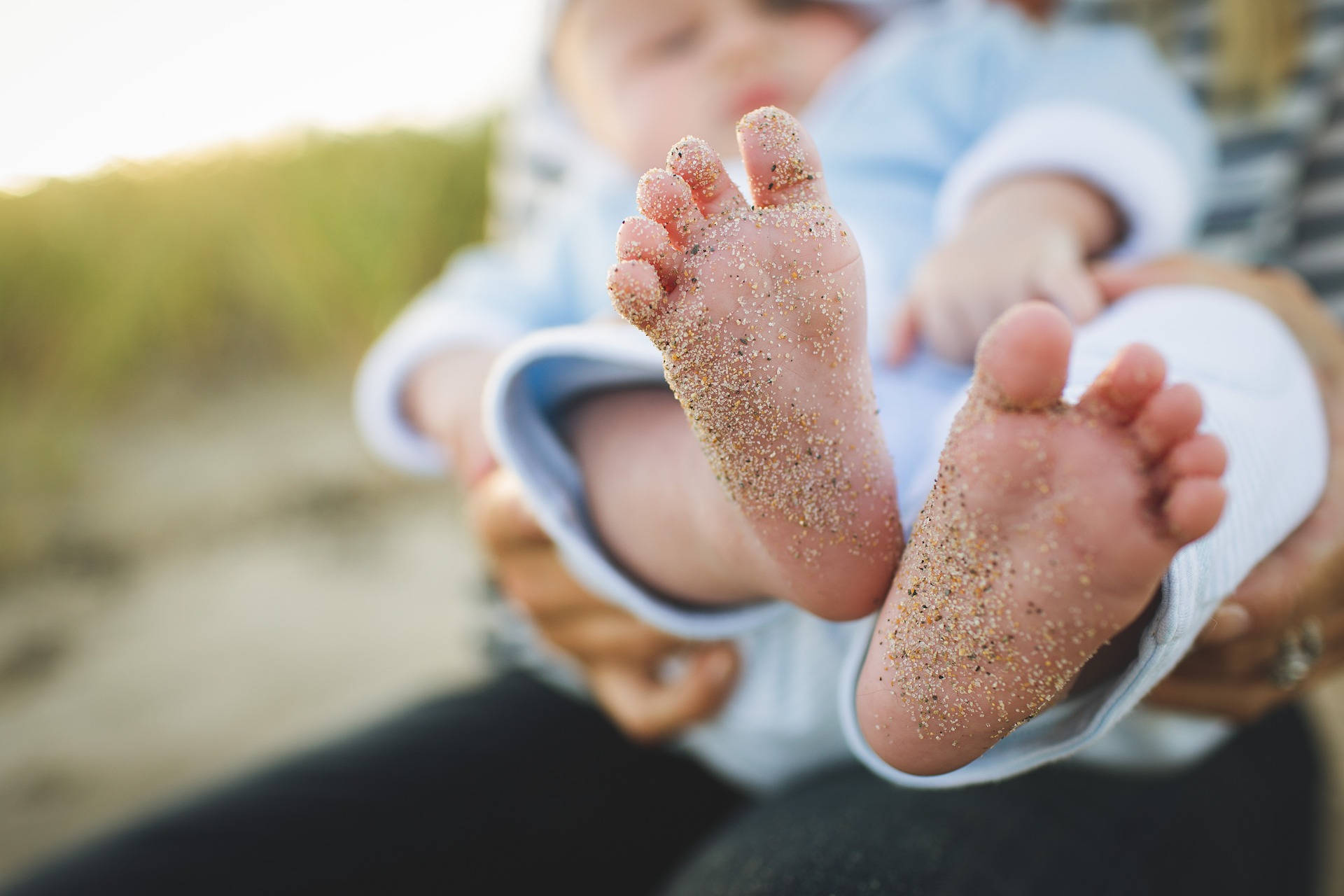 Very Cute Baby Feet With Sand Background