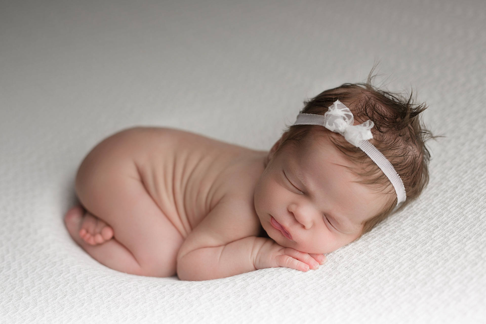 Very Cute Baby In Fetal Position Background