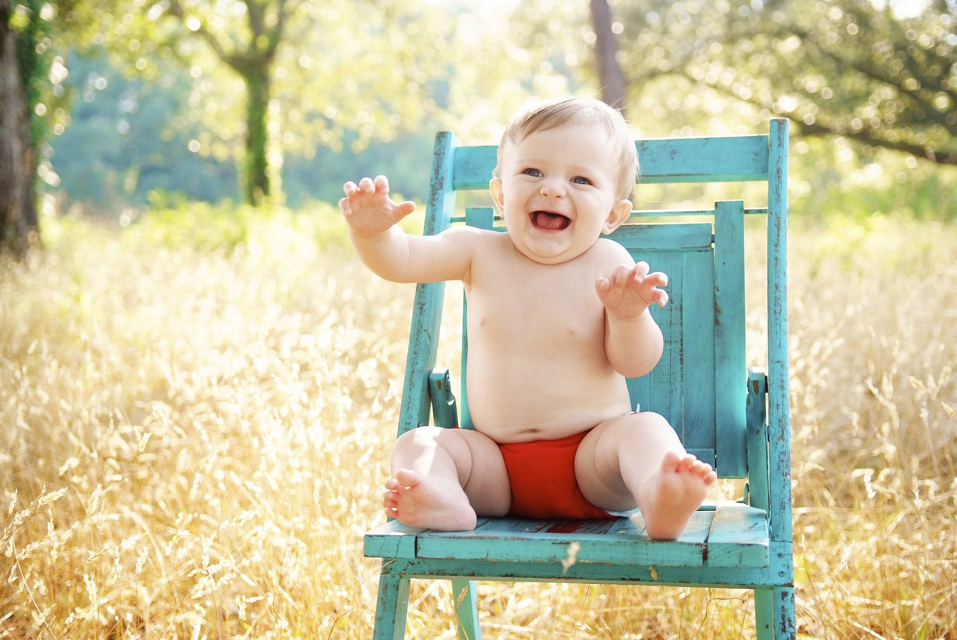 Very Cute Baby Laughing On Chair Background
