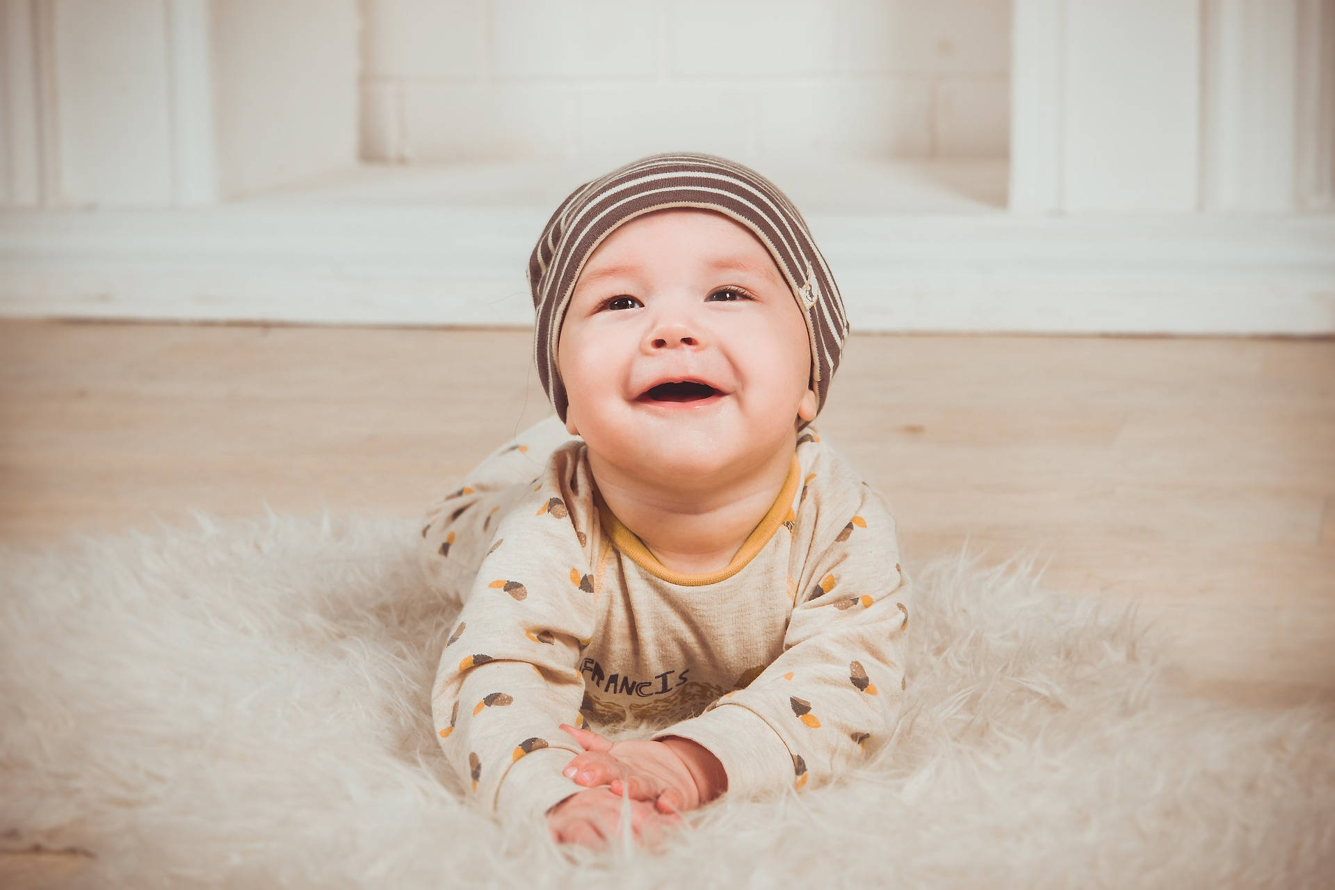 Very Cute Baby On Fluffy Rug Background