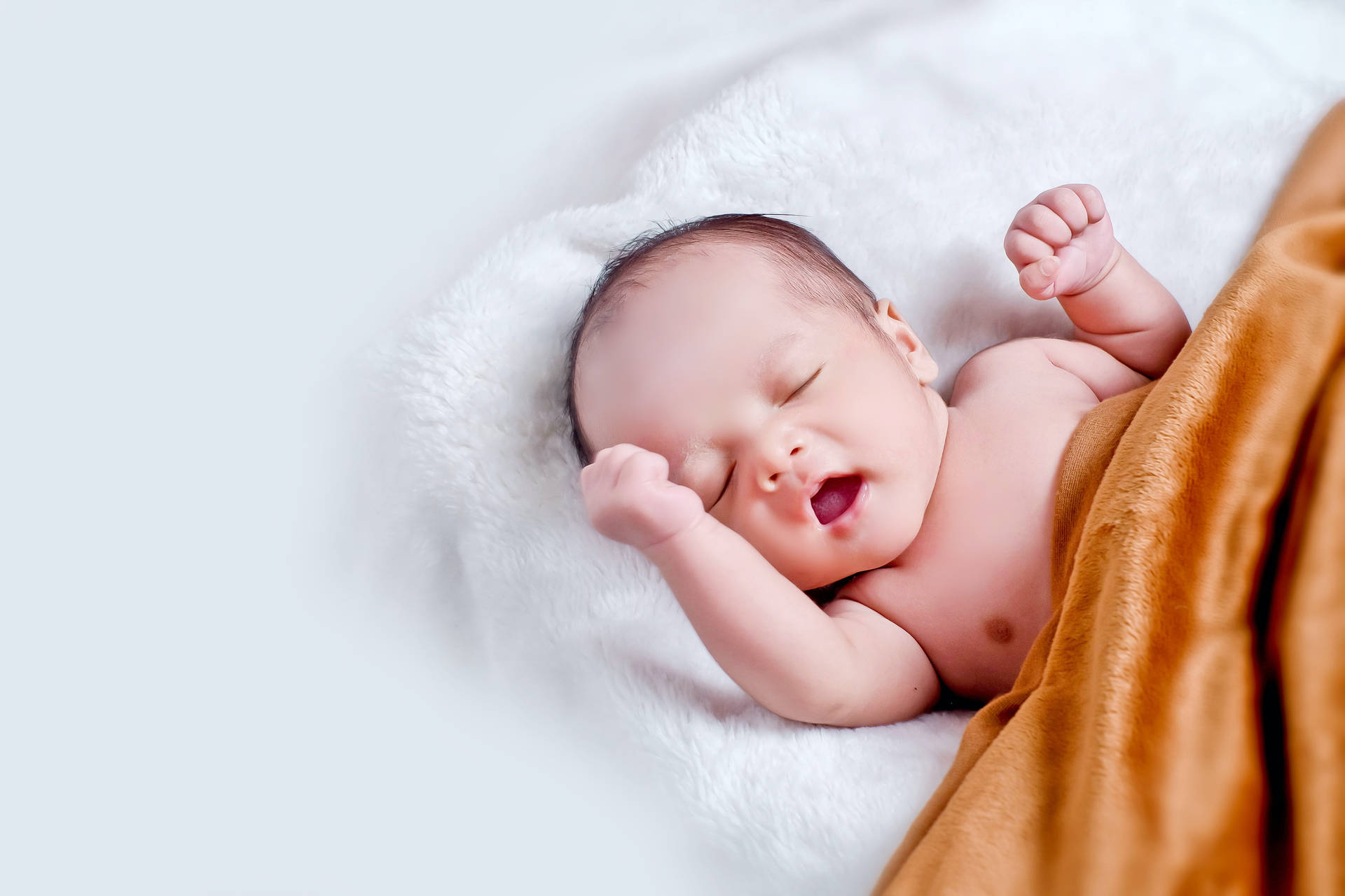 Very Cute Baby With Orange Blanket Background