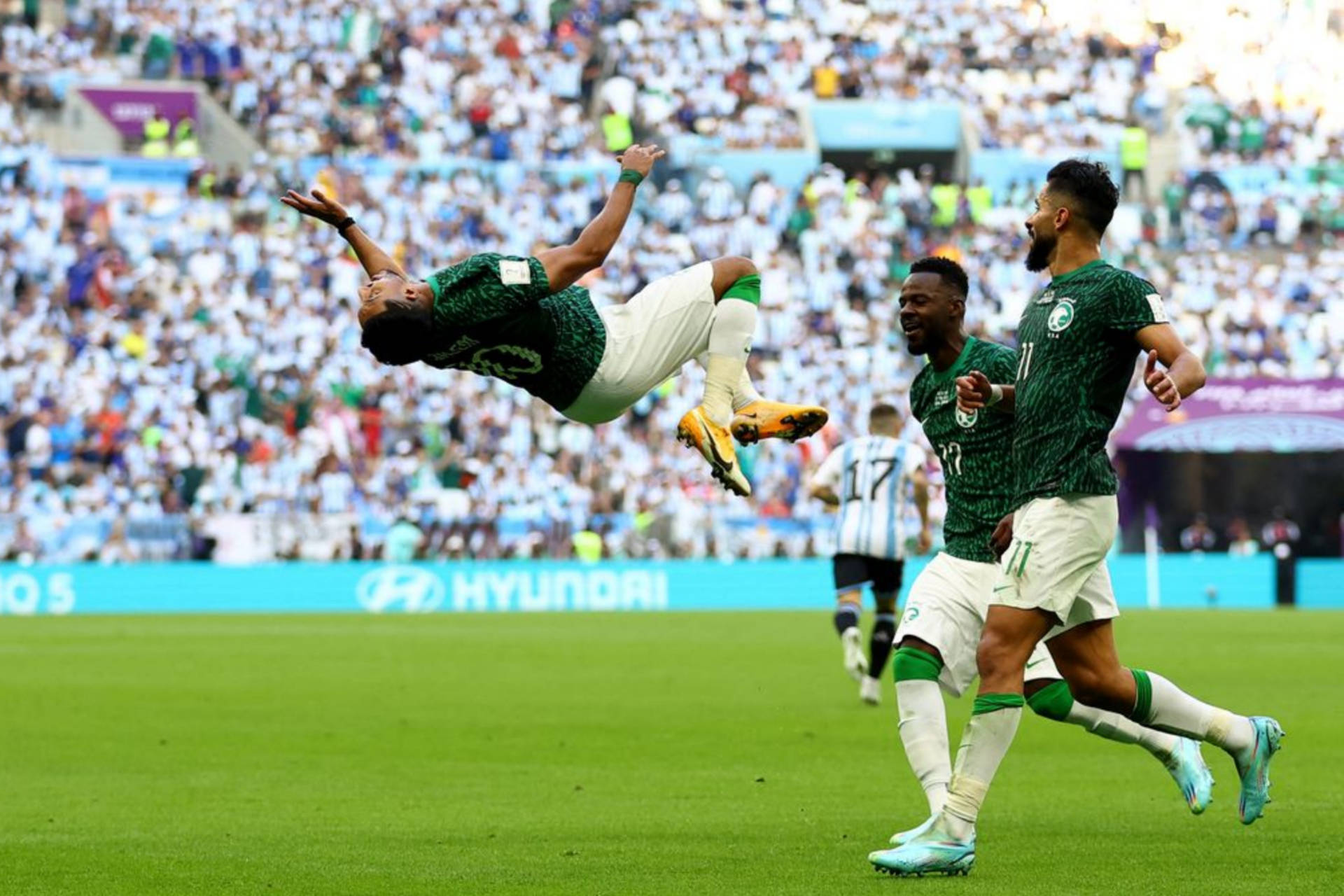 Vibrant Action Shot - Saudi Arabia National Football Team In Full Swing Background