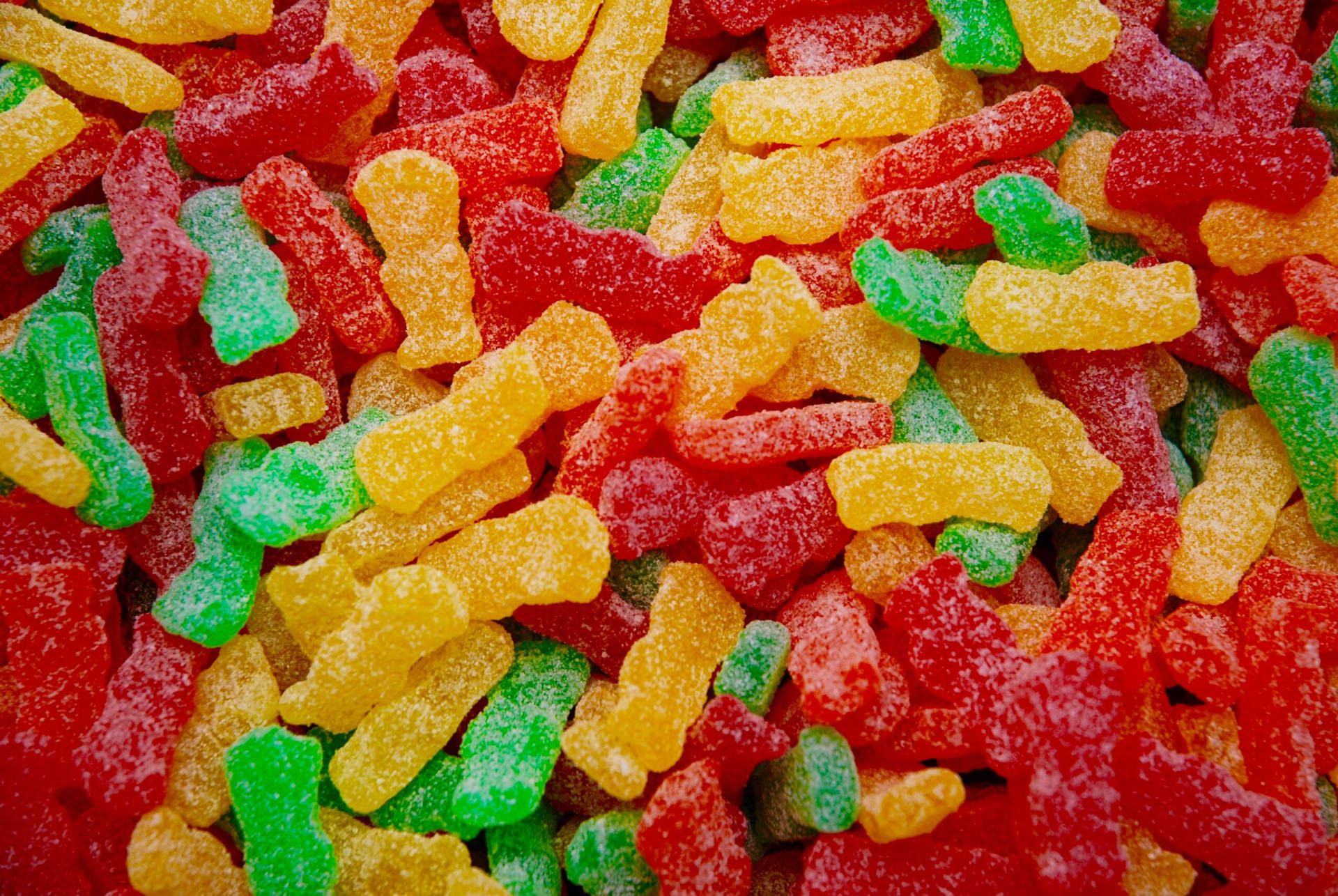 Vibrant Assortment Of Sour Gummy Worms Background