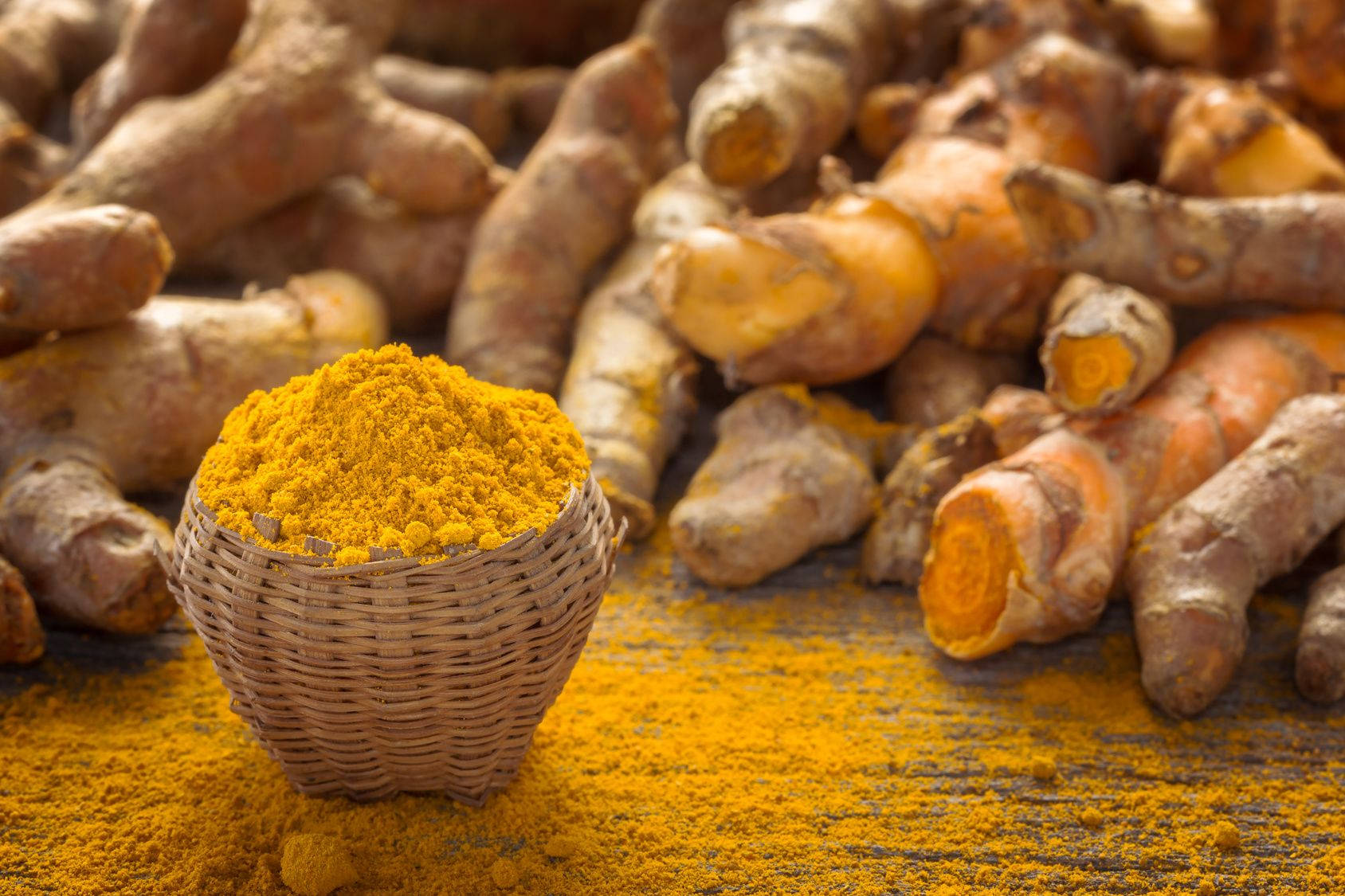 Vibrant Basket Of Turmeric Powder And Whole Turmeric