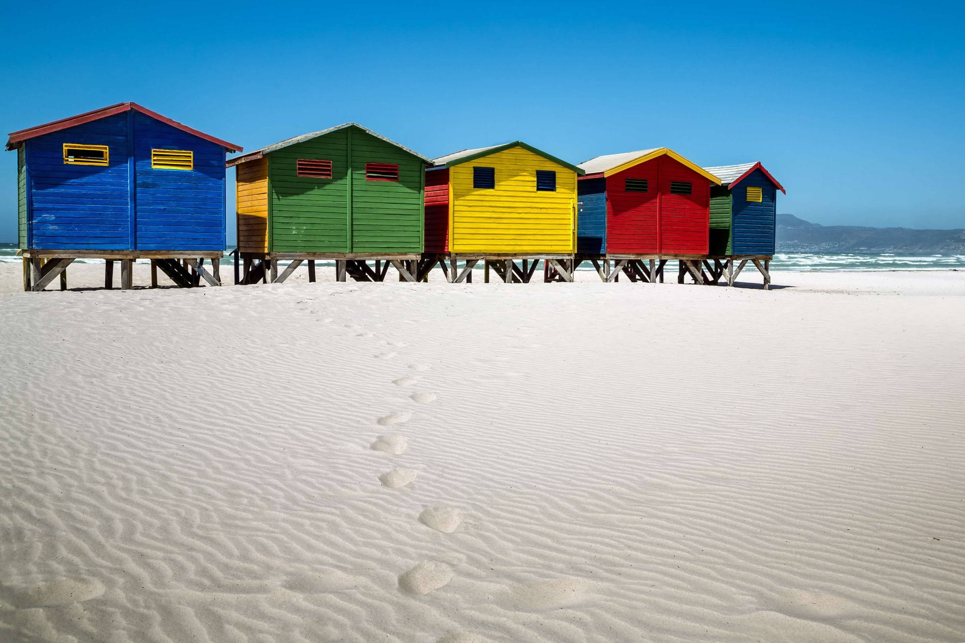 Vibrant Beach Huts In Cape Town Background