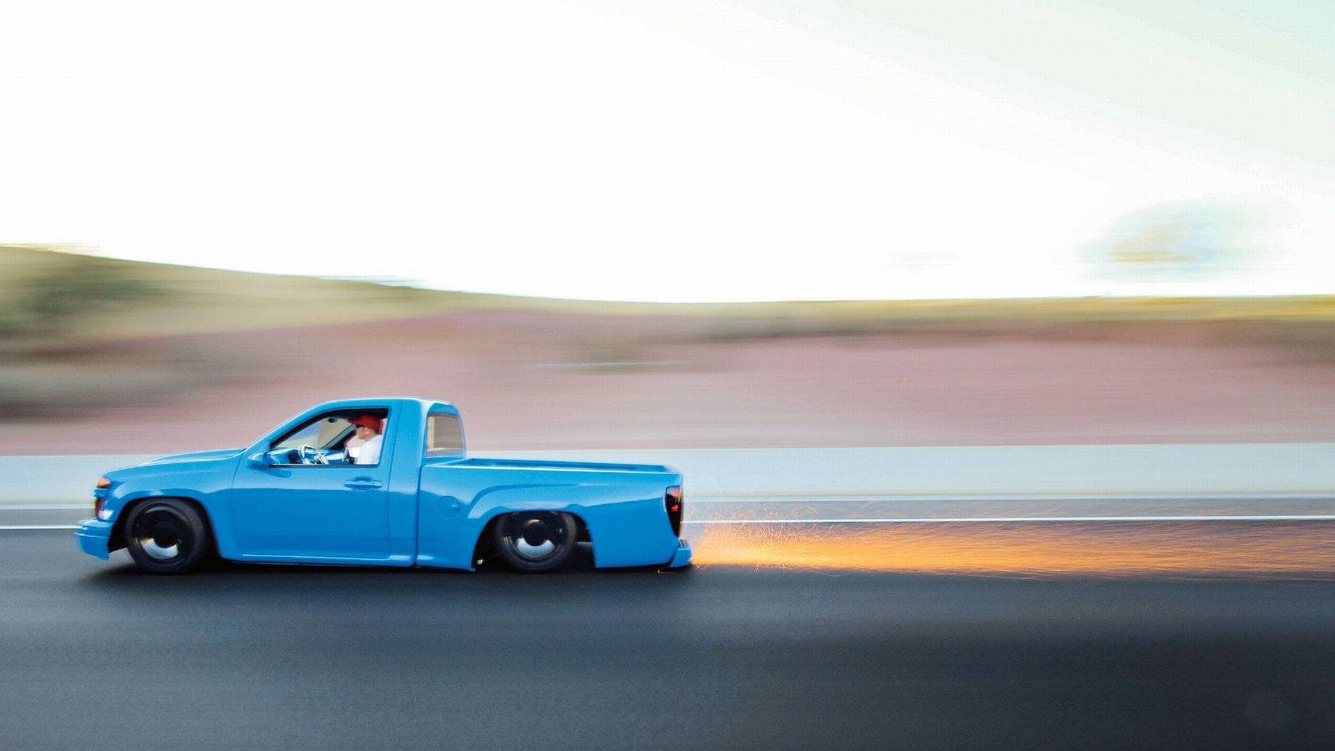Vibrant Blue Dropped Truck In Motion
