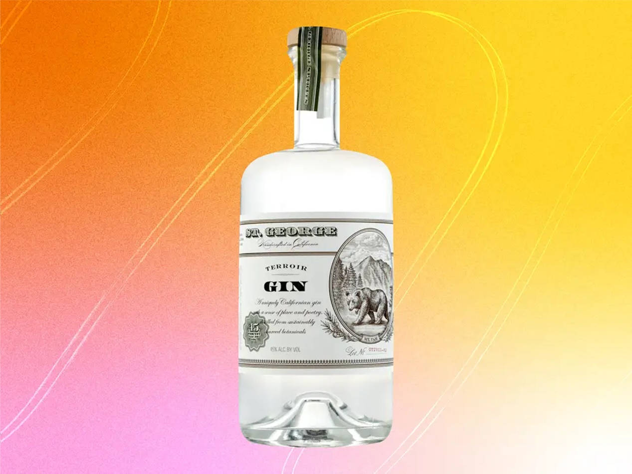 Vibrant Bottle Of St. George Terroir Gin Against An Orange Pink Background Background