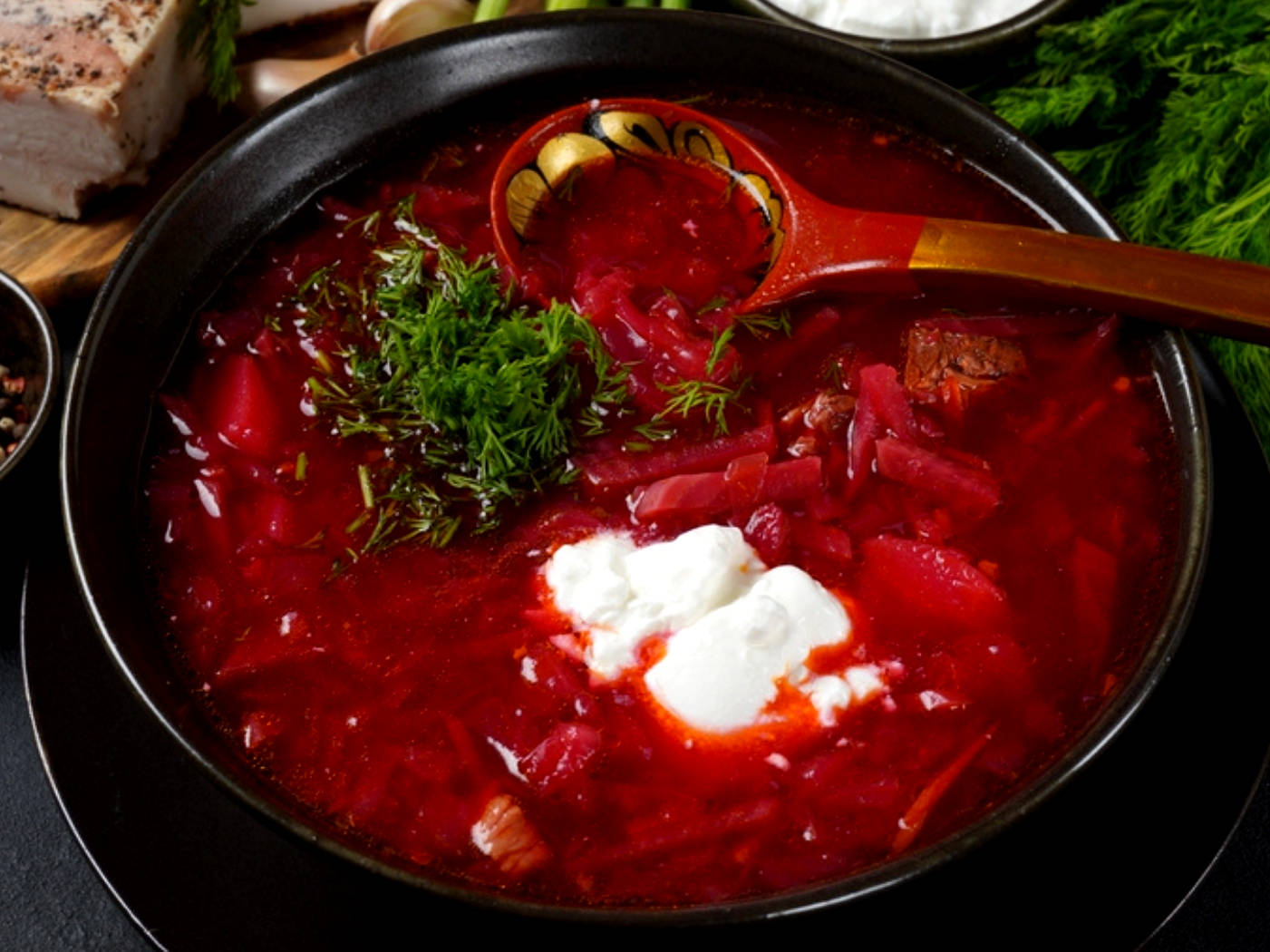 Vibrant Bowl Of Traditional Borscht Garnished With Sour Cream