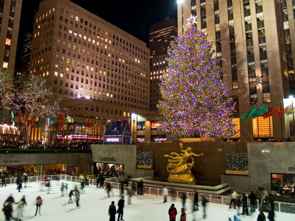 Vibrant Crowd Ice Skating At The Iconic Rockefeller Center