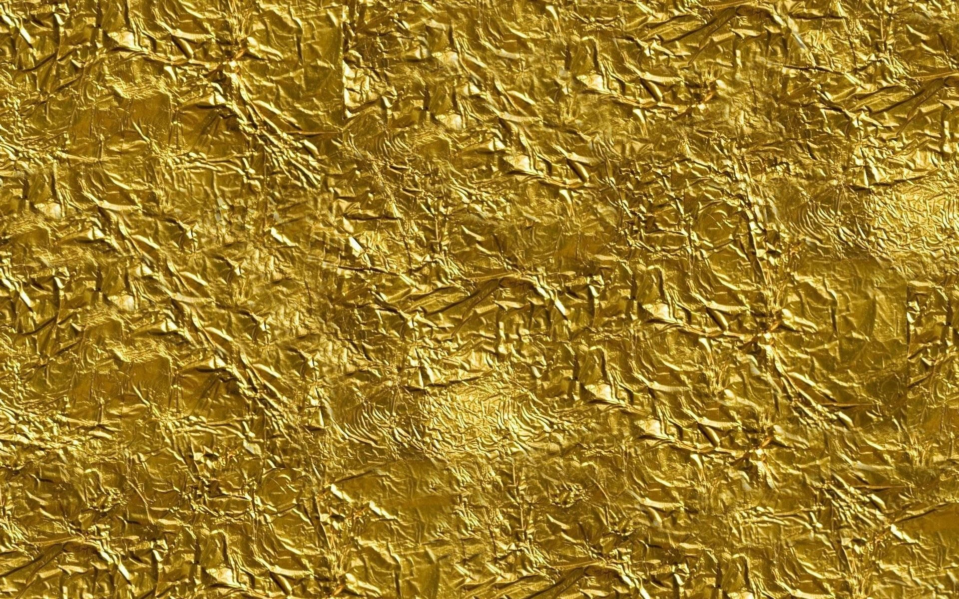Vibrant Crushed Gold Foil Texture Background