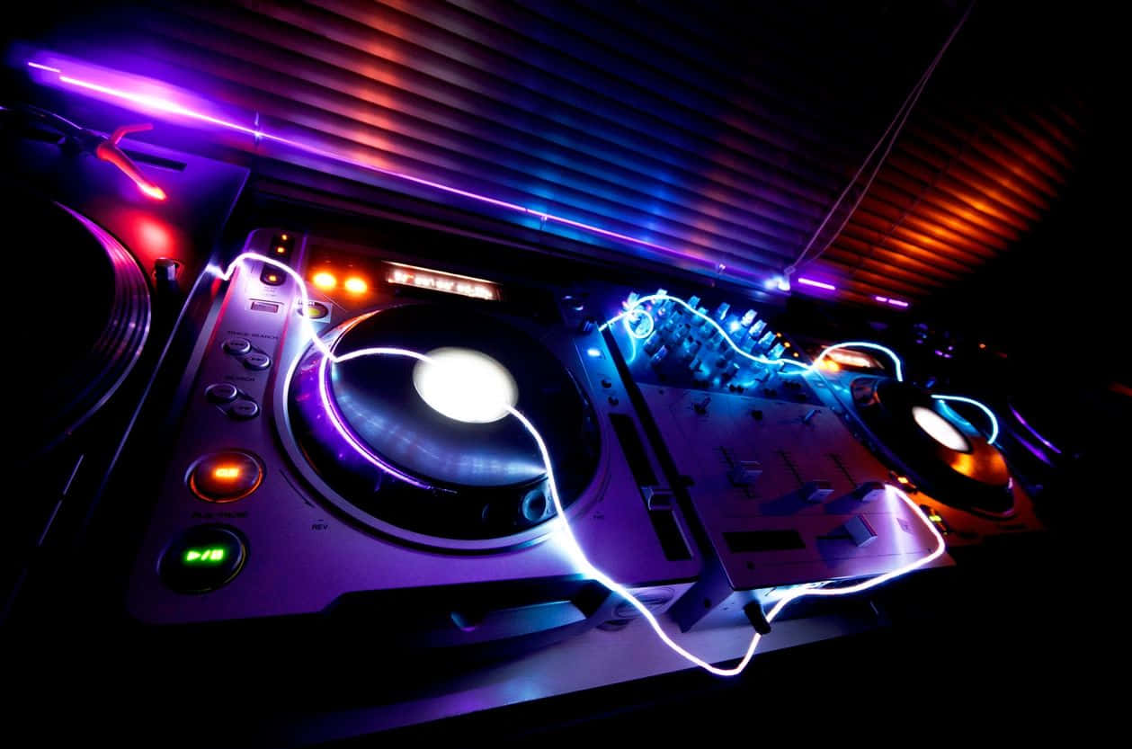 Vibrant D J Deck Under Club Lights Background
