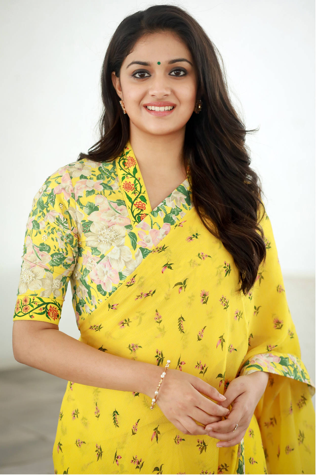 Vibrant Elegance - Keerthi Suresh In A Stunning Yellow Floral Saree Background